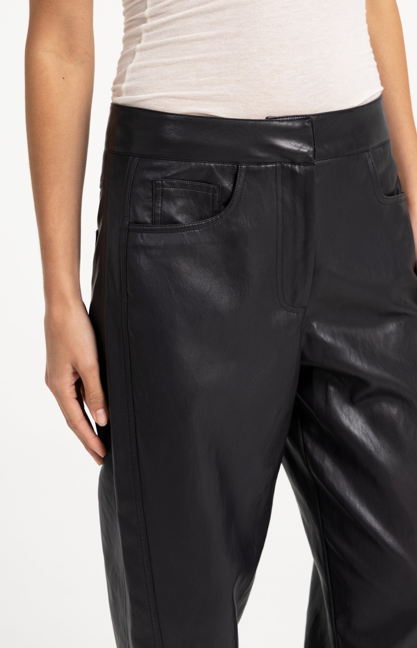 Faux leather carrot fit trousers with seam detail