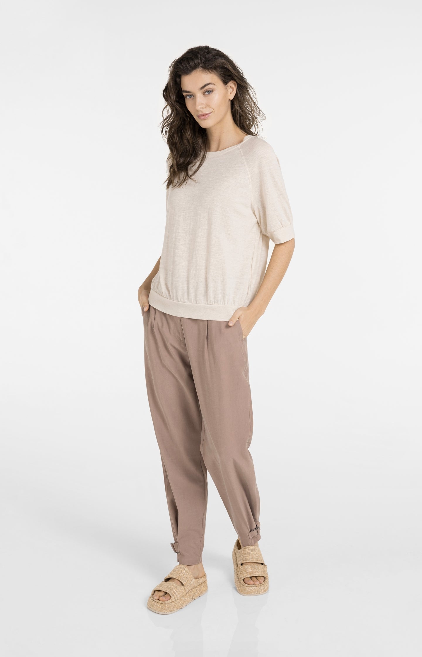 High waist trousers with strap details at the bottom hem