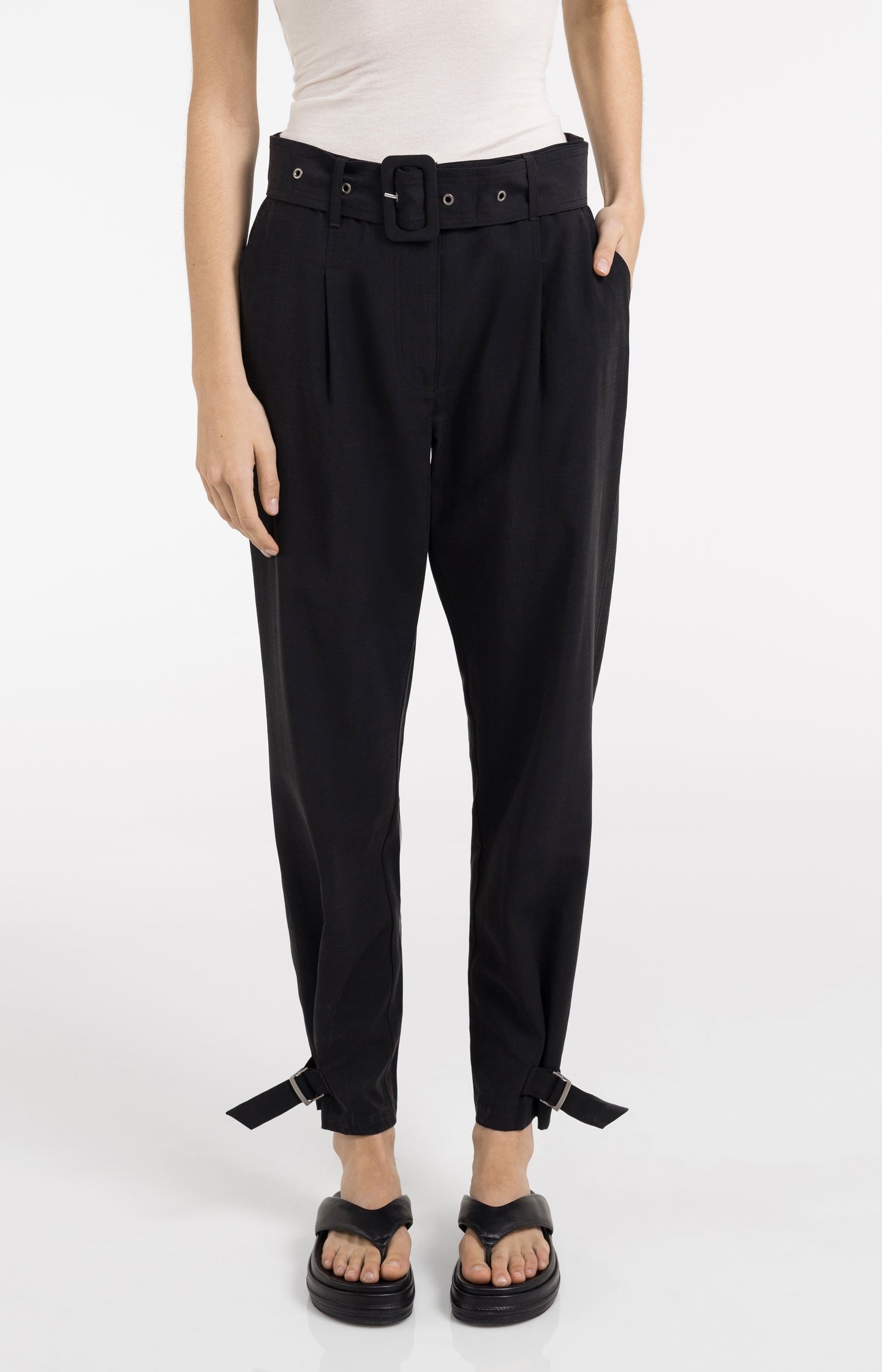 High waist trousers with strap details at the bottom hem