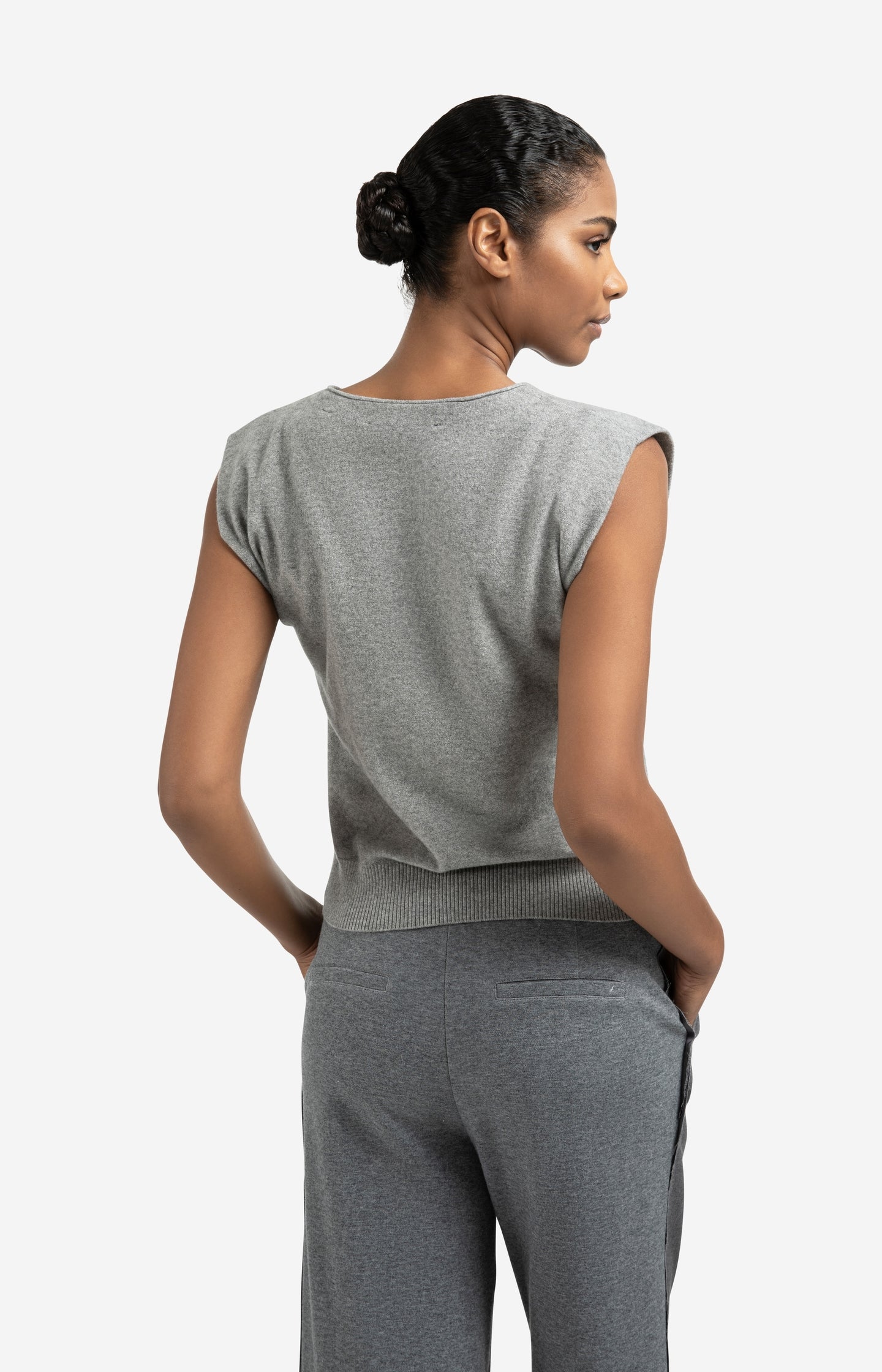Knitted gilet with V-neck and asymmetric buttoning