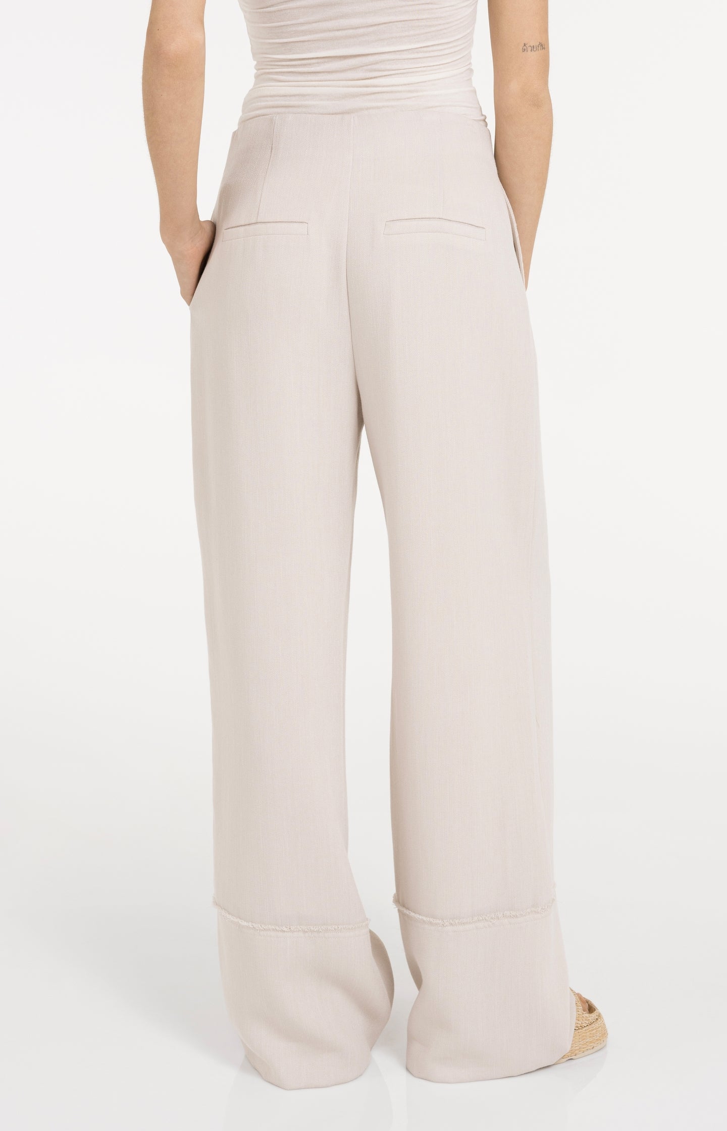 Linen blend trousers with wide legs and fringed details