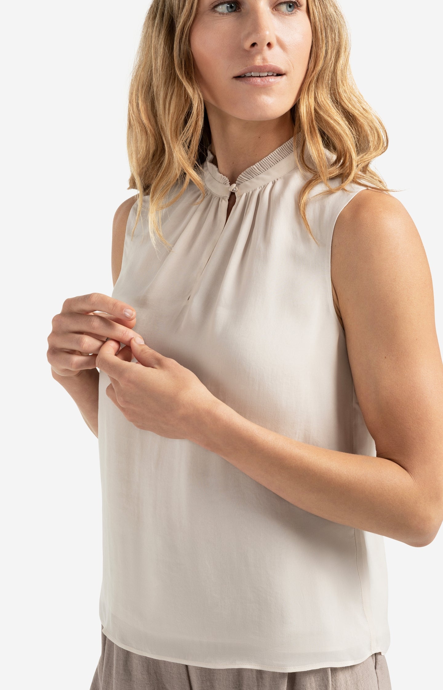 Sleeveless top with ruffled collar and keyhole detail