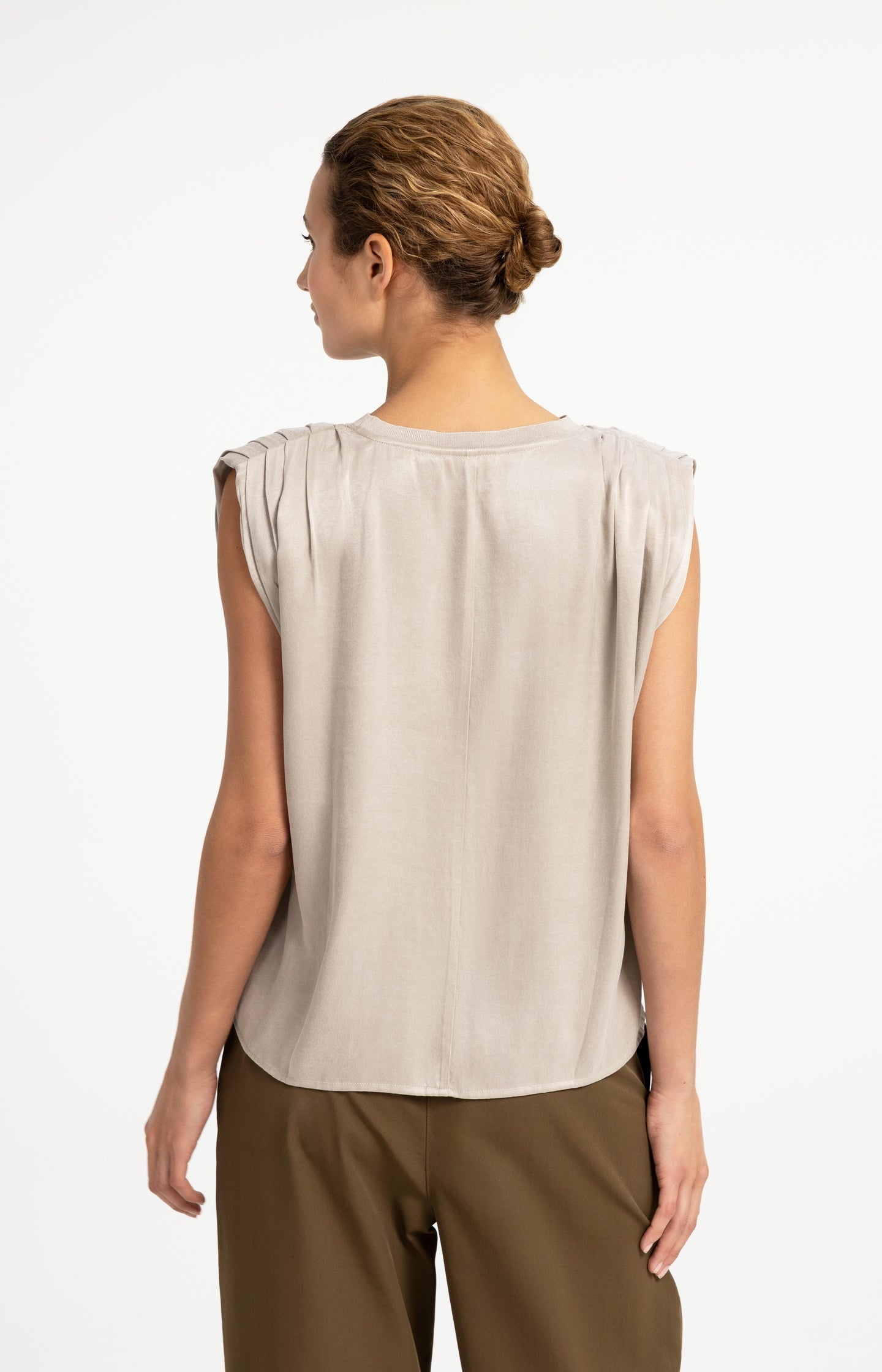Sleeveless top with shoulder pleats