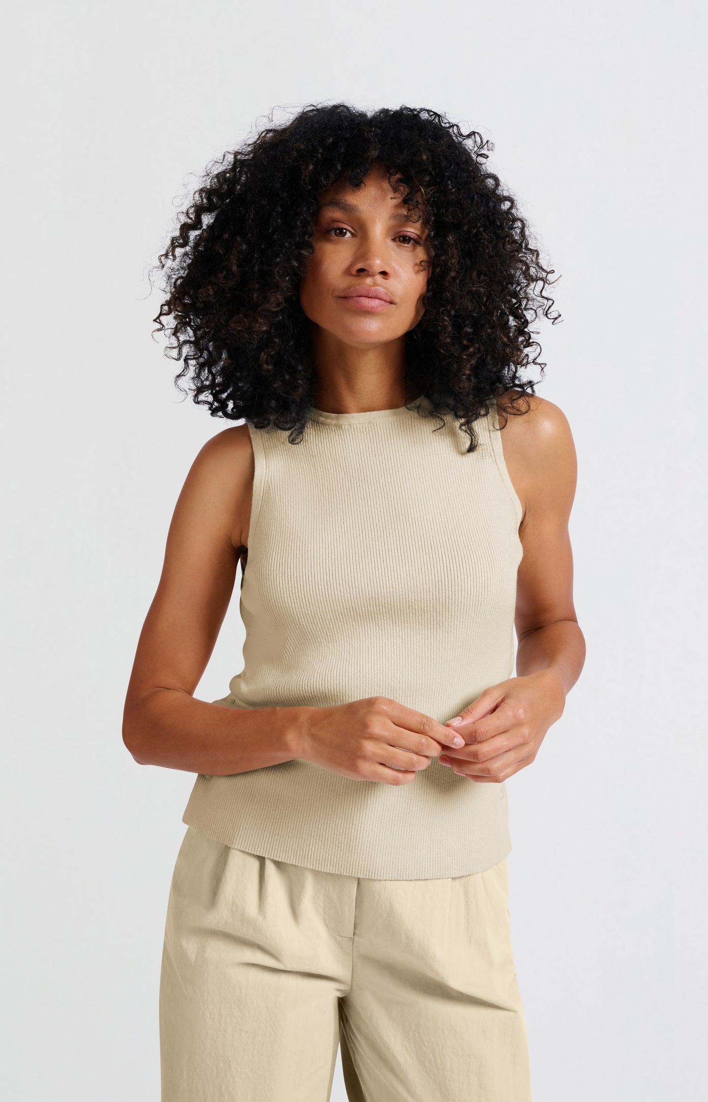 Sleeveless top with side button details and fitted fit
