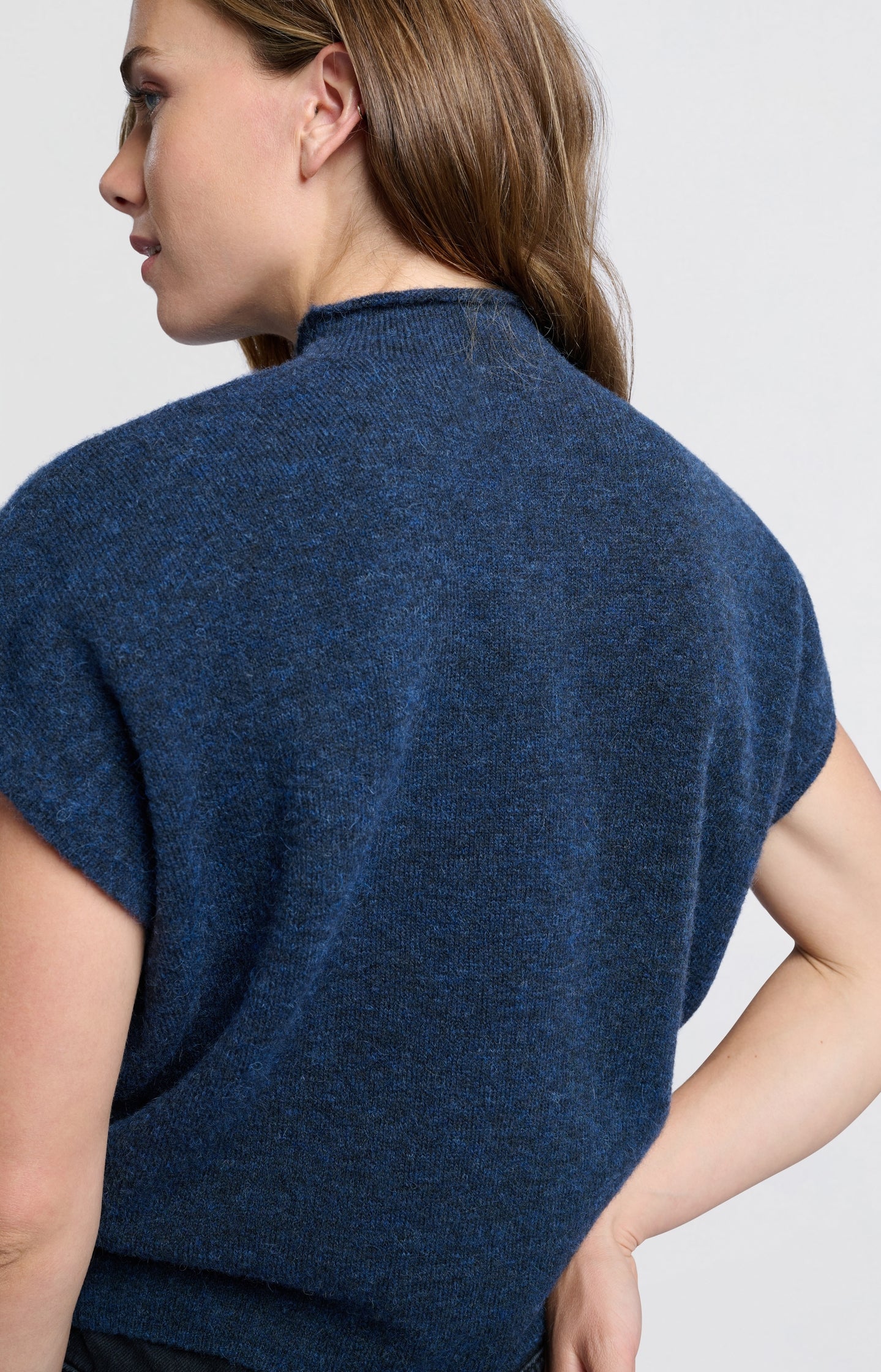 Soft sleeveless sweater with high neck and loose fit