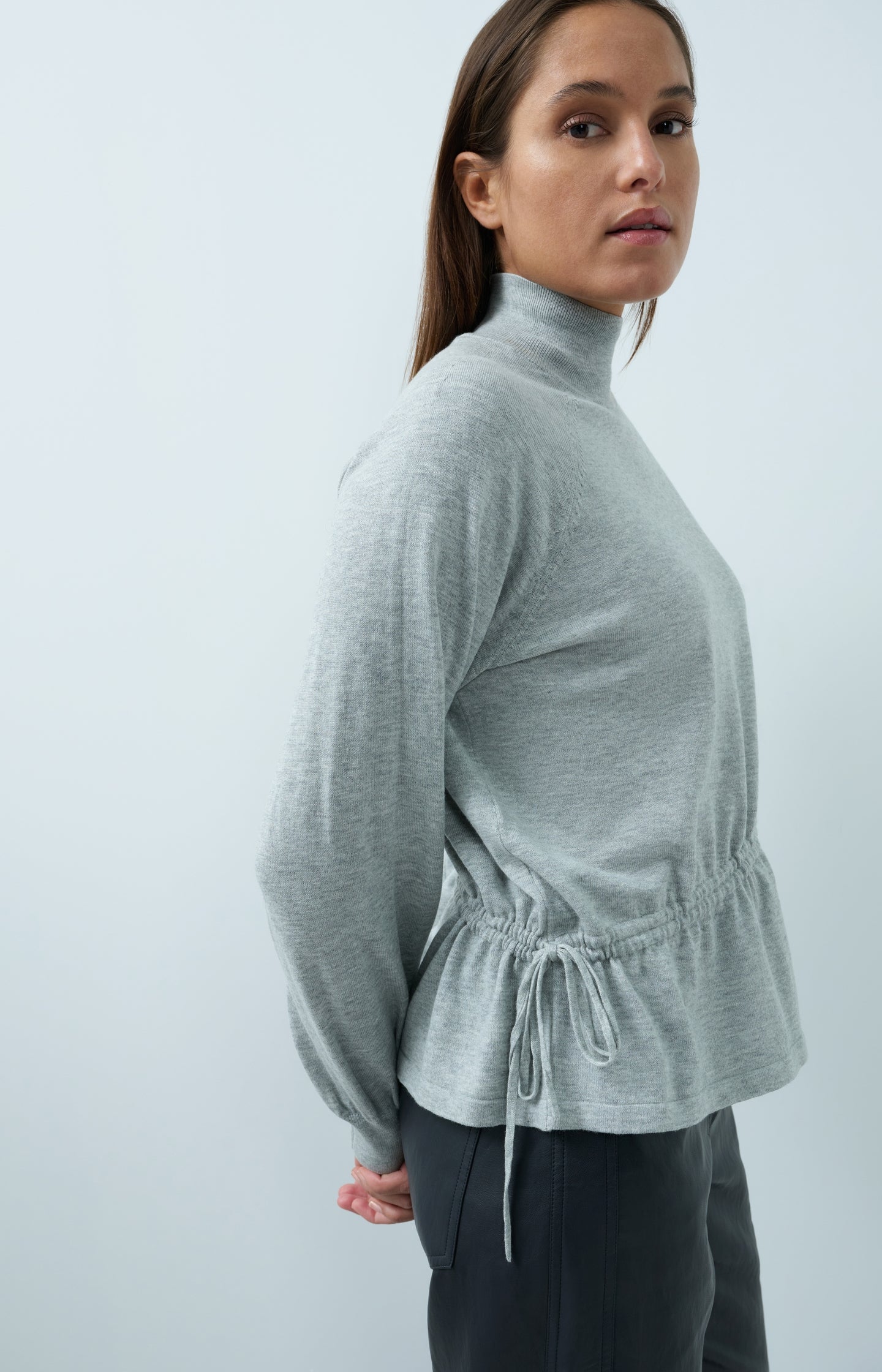 Sweater with high neckline and waist cord