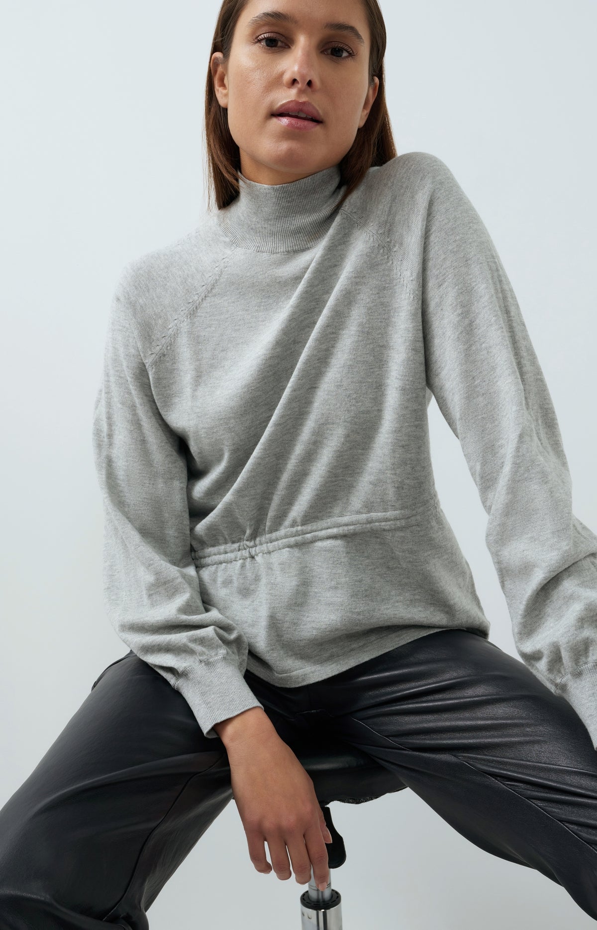 Sweater with high neckline and waist cord