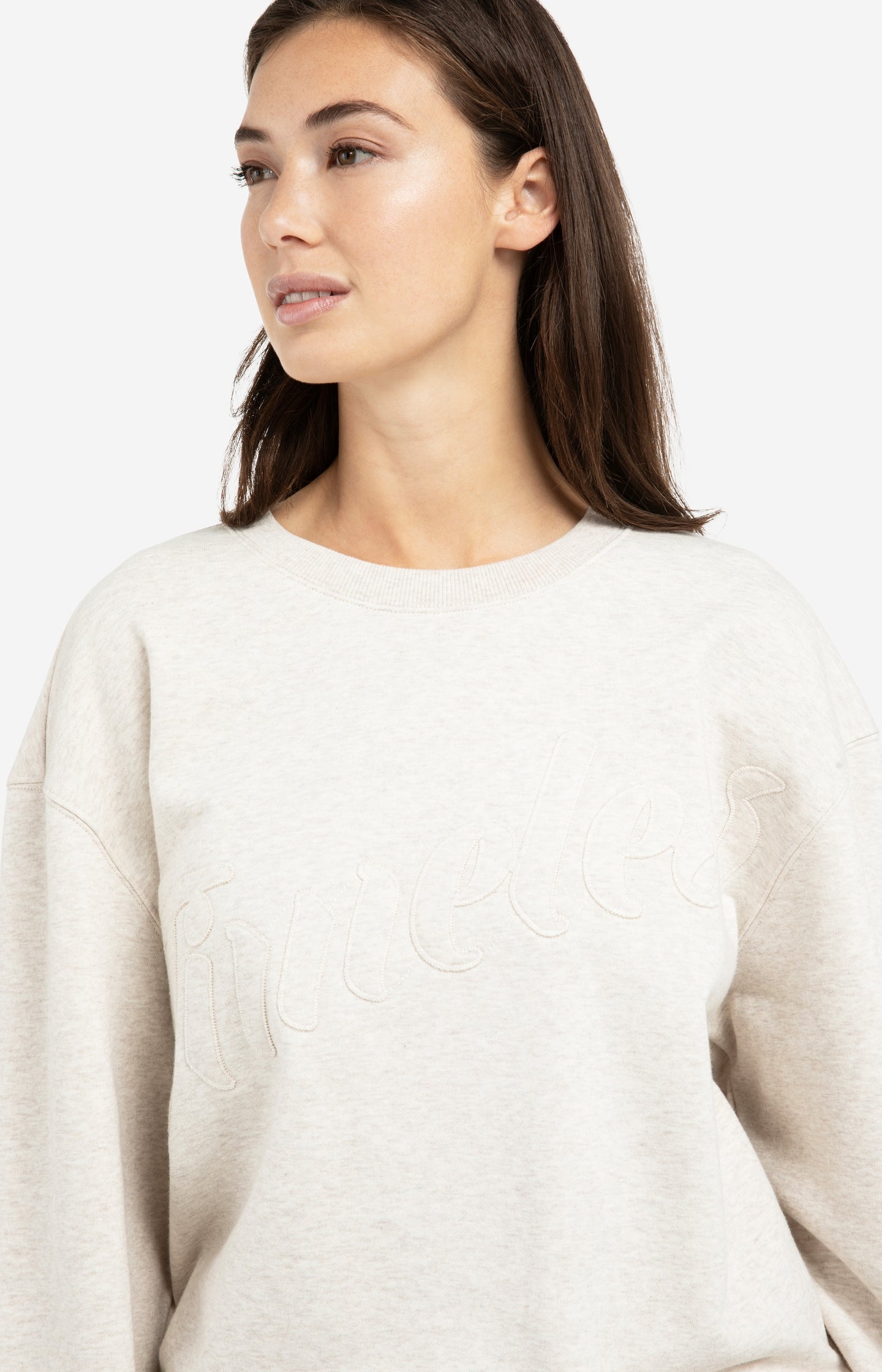 Sweater with stitched-on text and round neckline