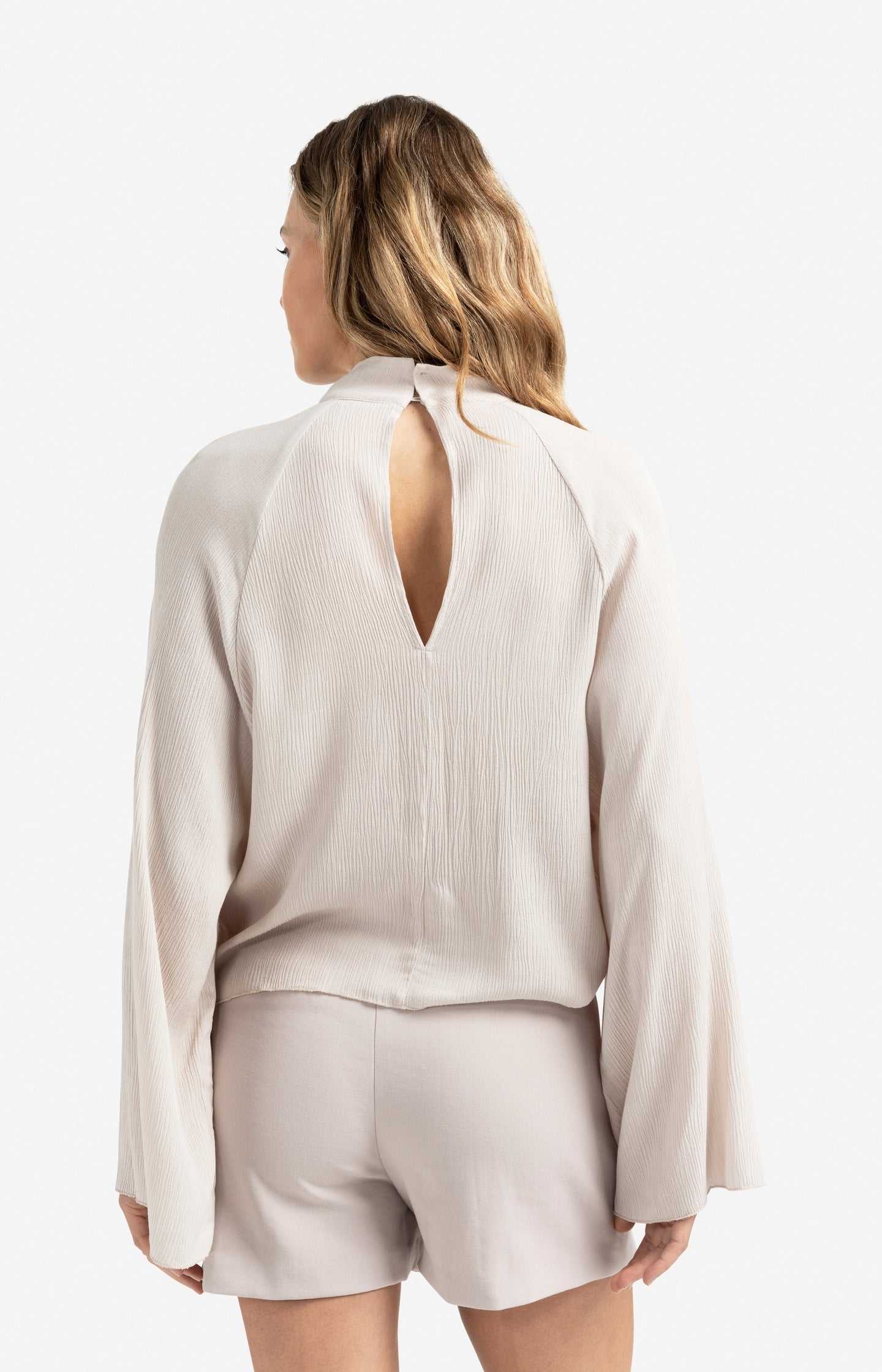 Textured top with high neck and raglan sleeves