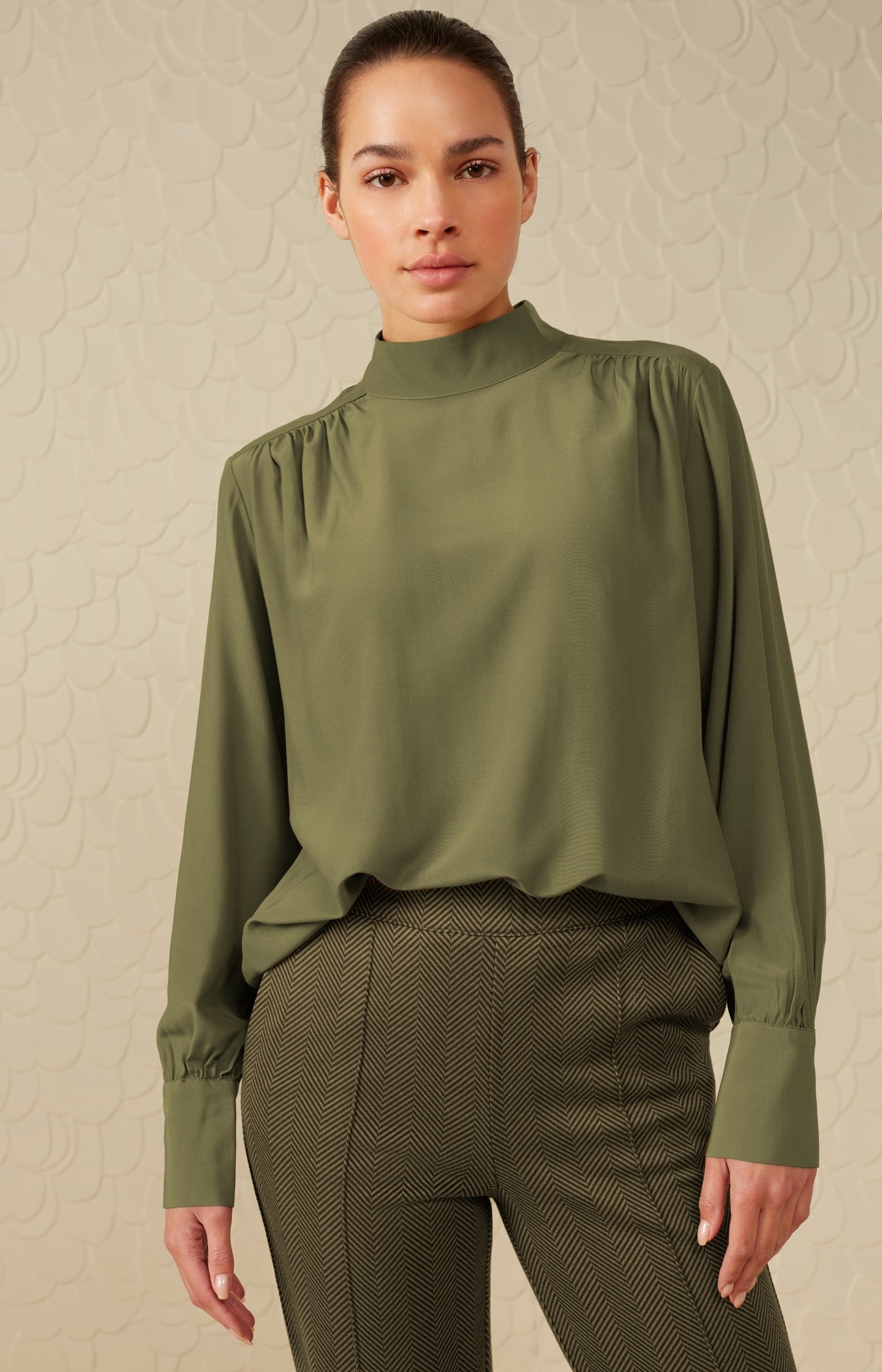 Top with high neck, long puffed sleeves and gathered details
