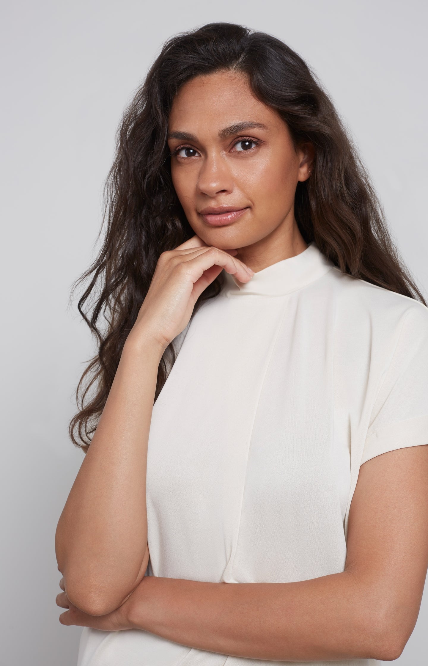 Top with high round neck, short sleeves and pleat detail