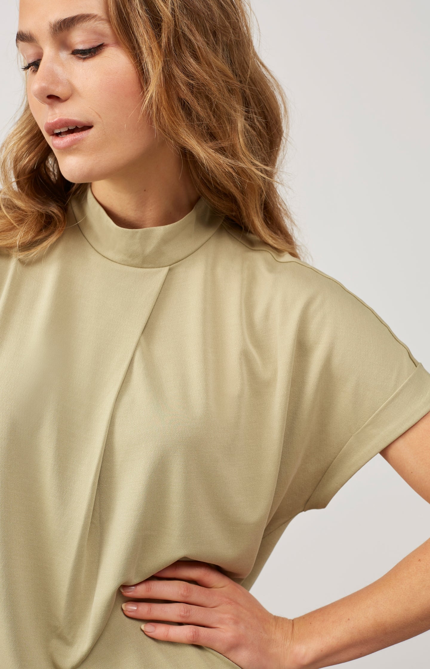 Top with high round neck, short sleeves and pleat detail