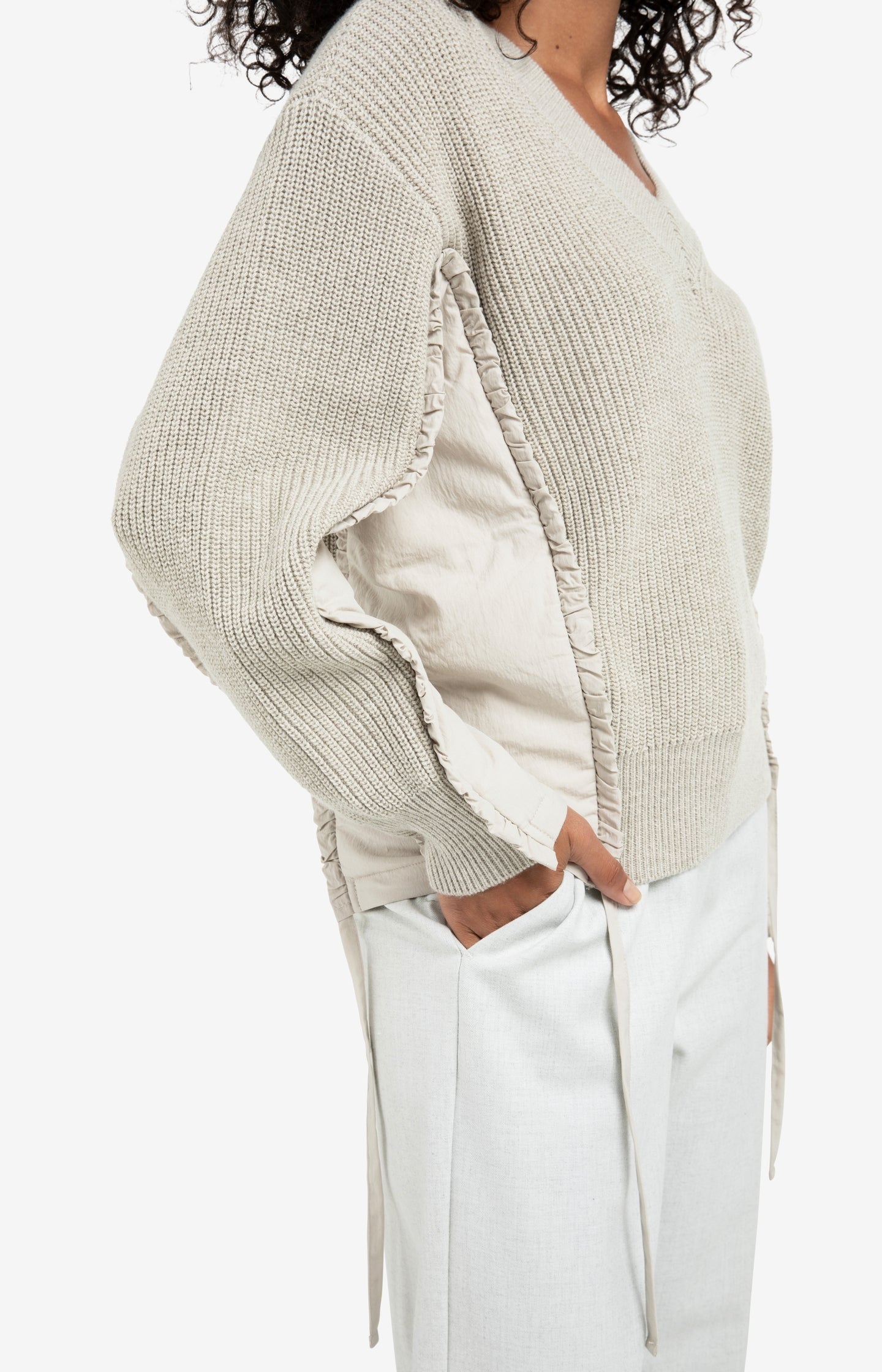 V-neck sweater with woven insert details and tie accents