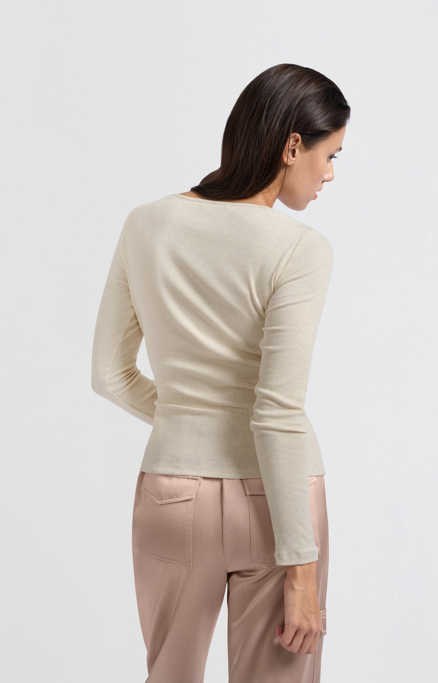 Beige top with long sleeves and asymmetrical button details