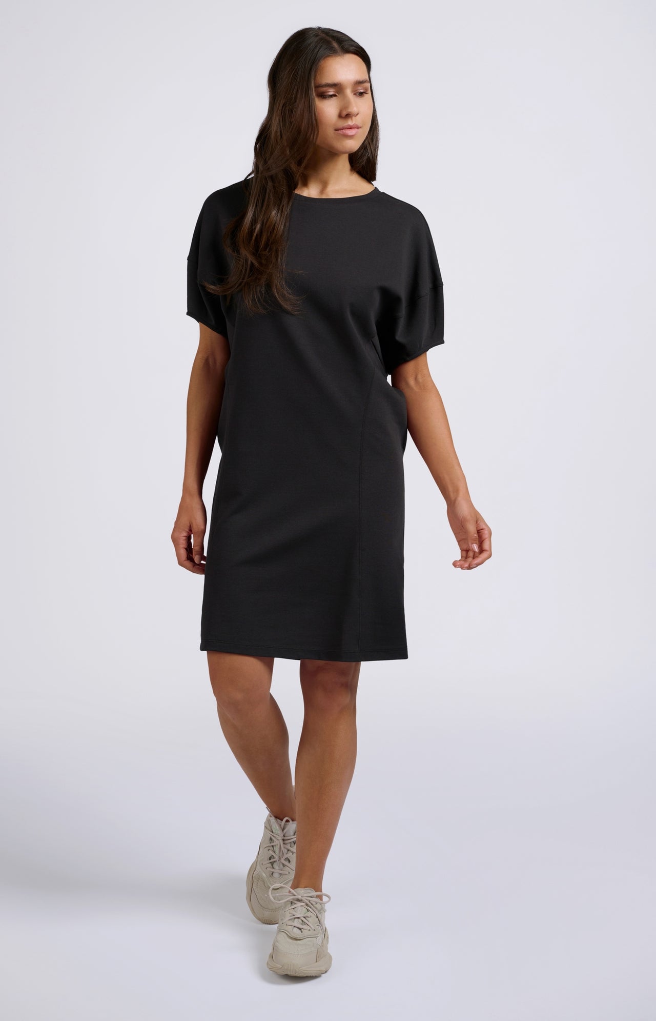 Black dress with short wide sleeves, round neck and pleats