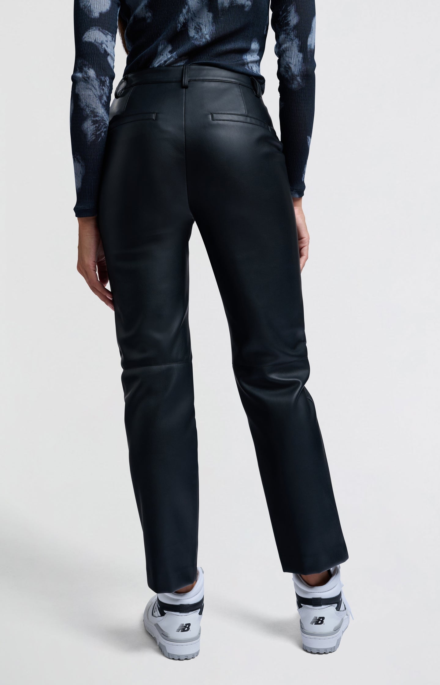 Black faux leather pants with high waist and straight legs