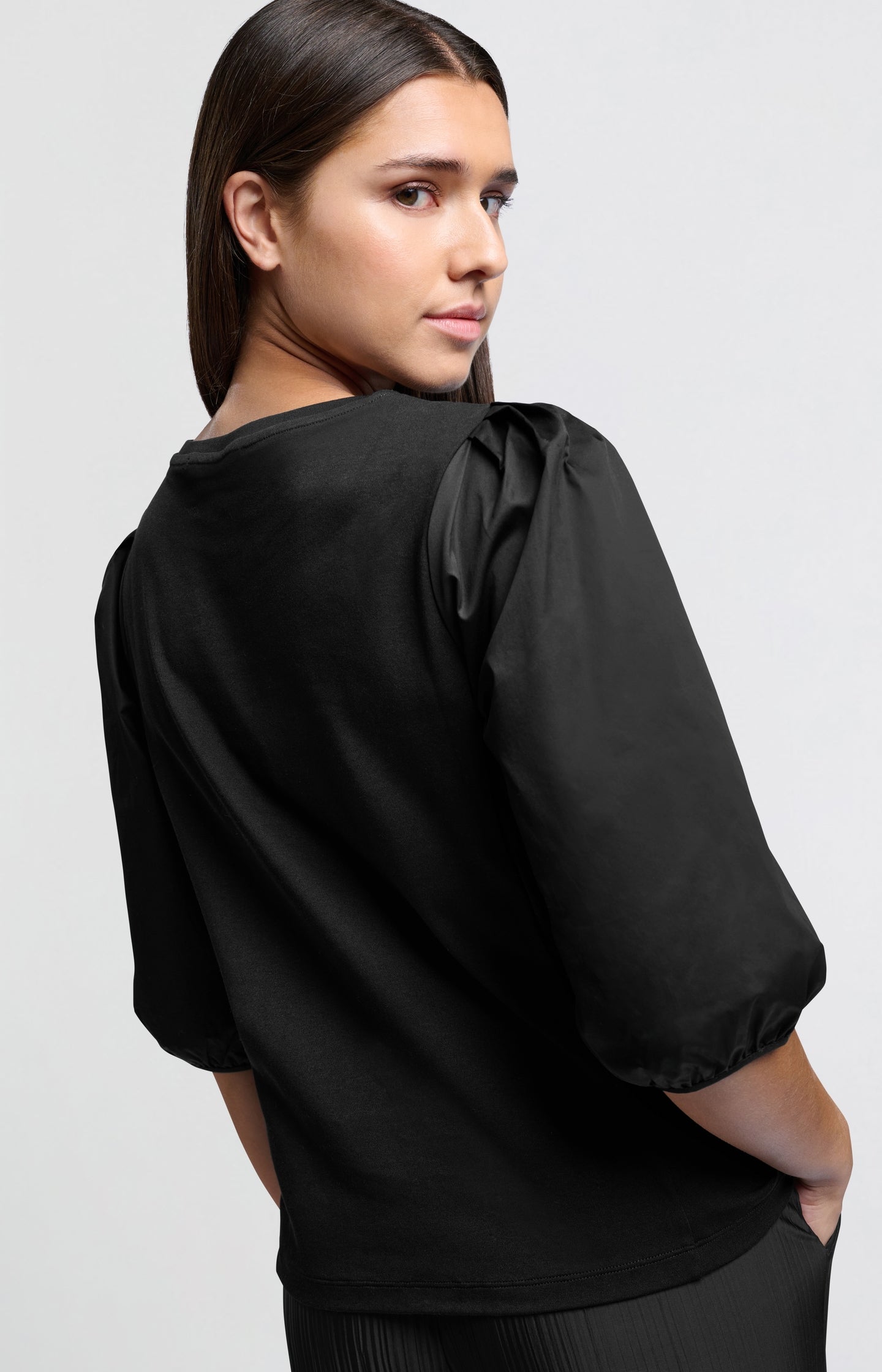 Black jersey top with puffed sleeves