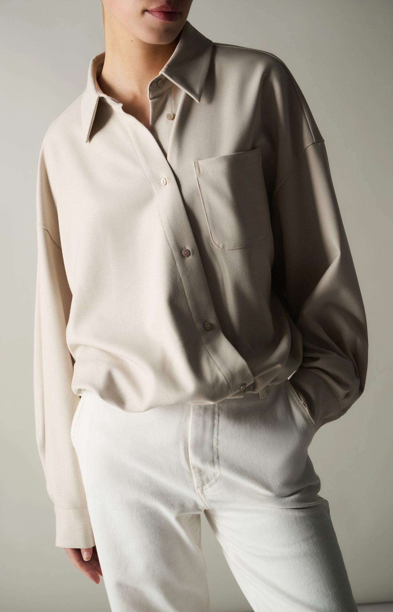 Blouse with asymmetric button placket and elastic hem