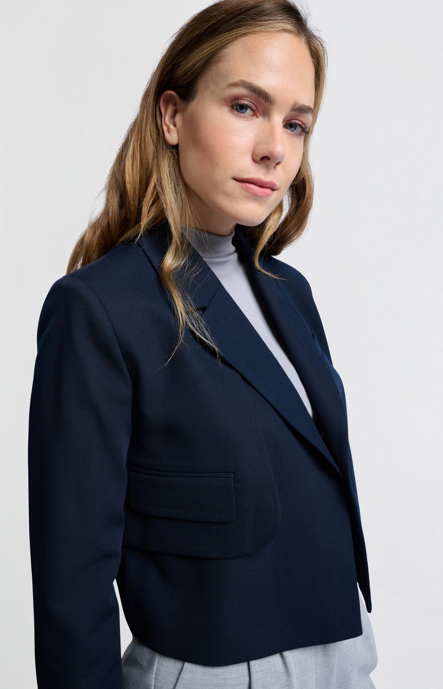 Dark blue woven cropped blazer with unique pocket detail