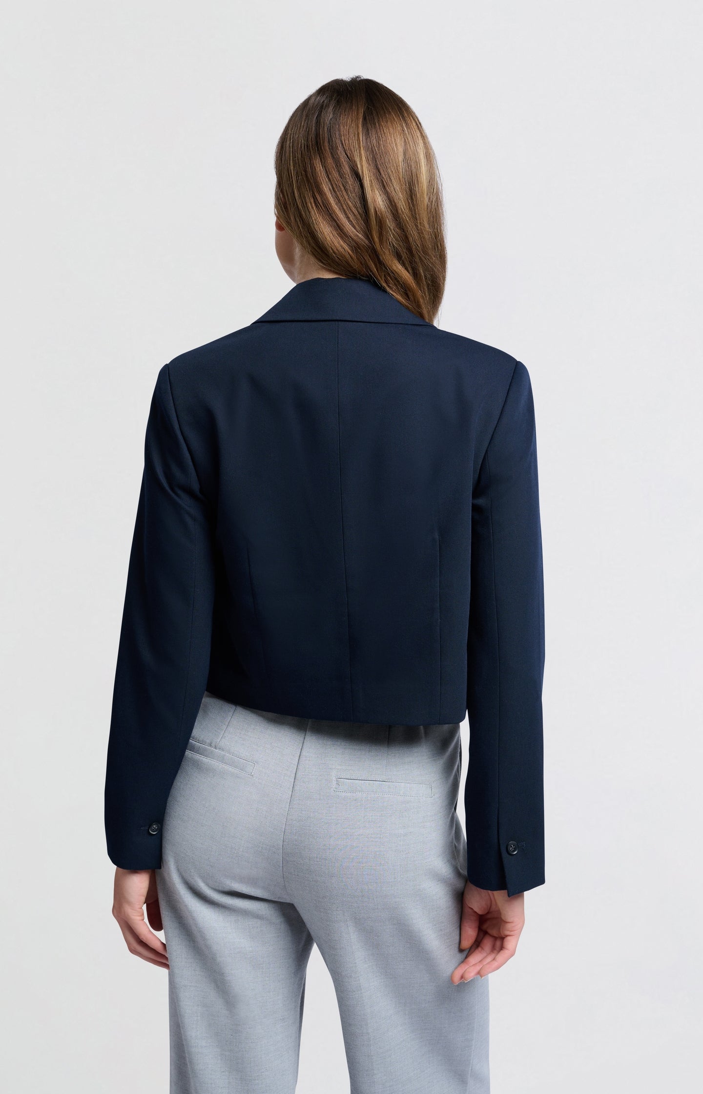 Dark blue woven cropped blazer with unique pocket detail