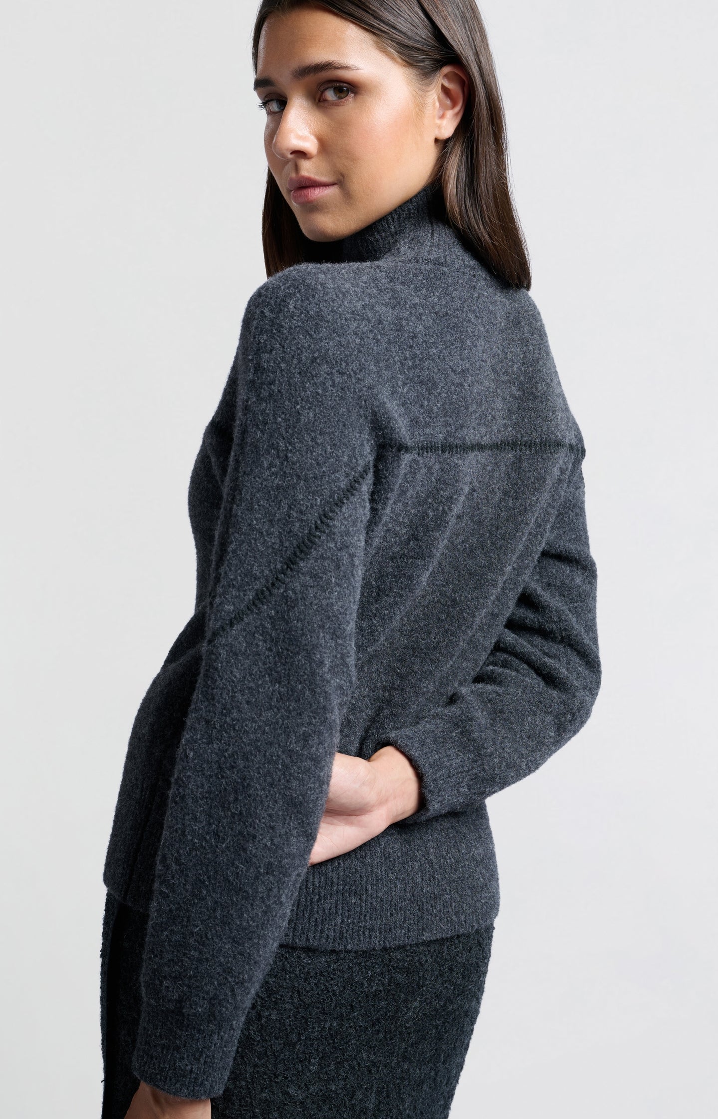 Dark grey sweater with subtle seam detail and high collar