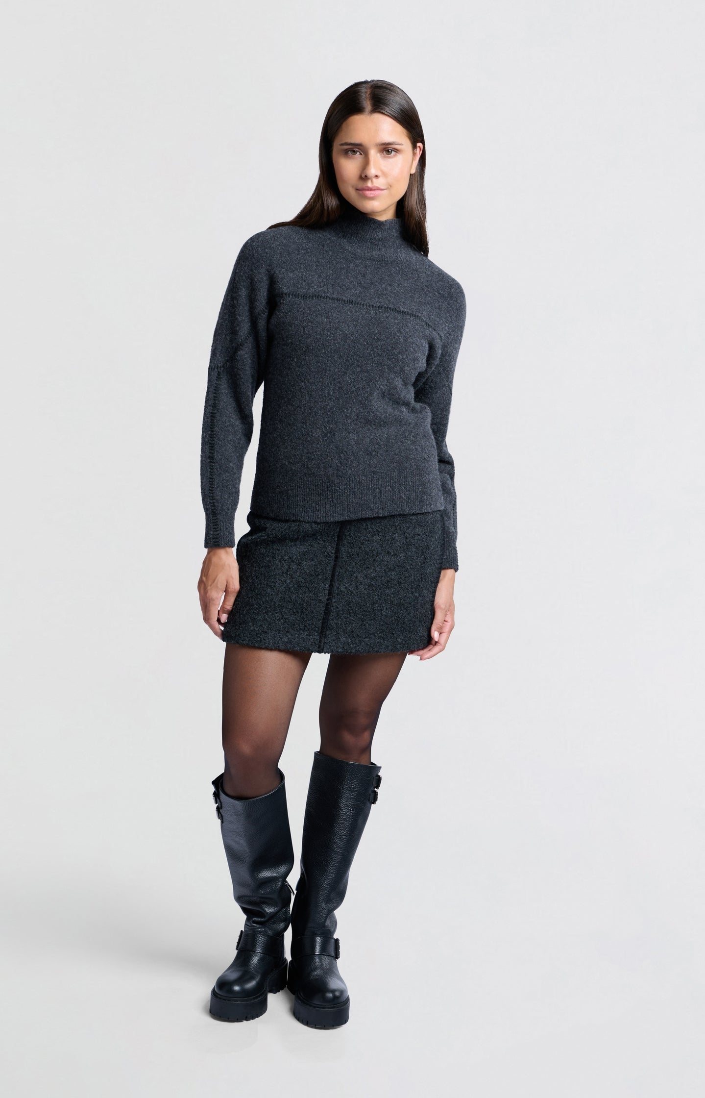 Dark grey sweater with subtle seam detail and high collar