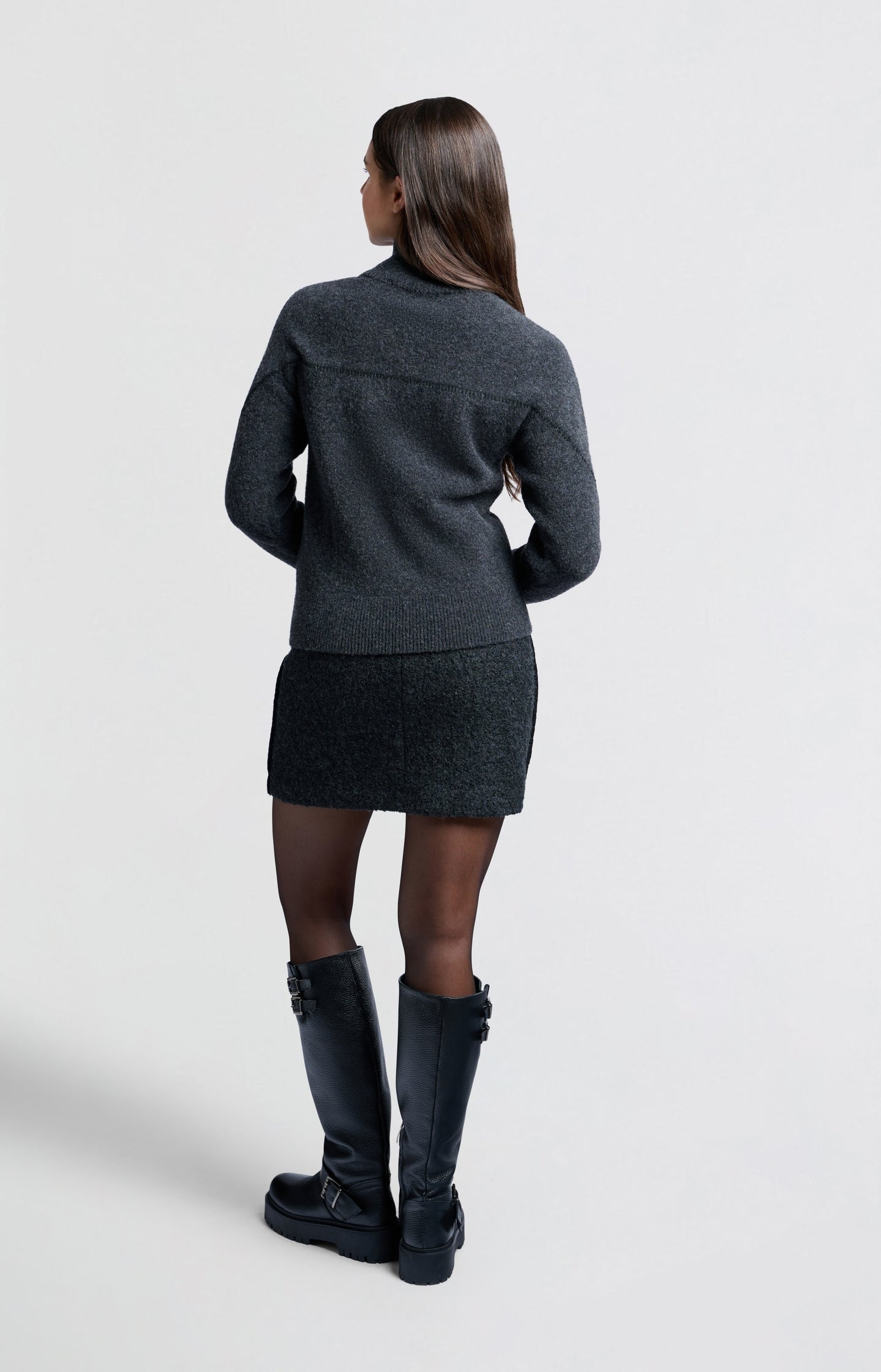 Dark grey sweater with subtle seam detail and high collar