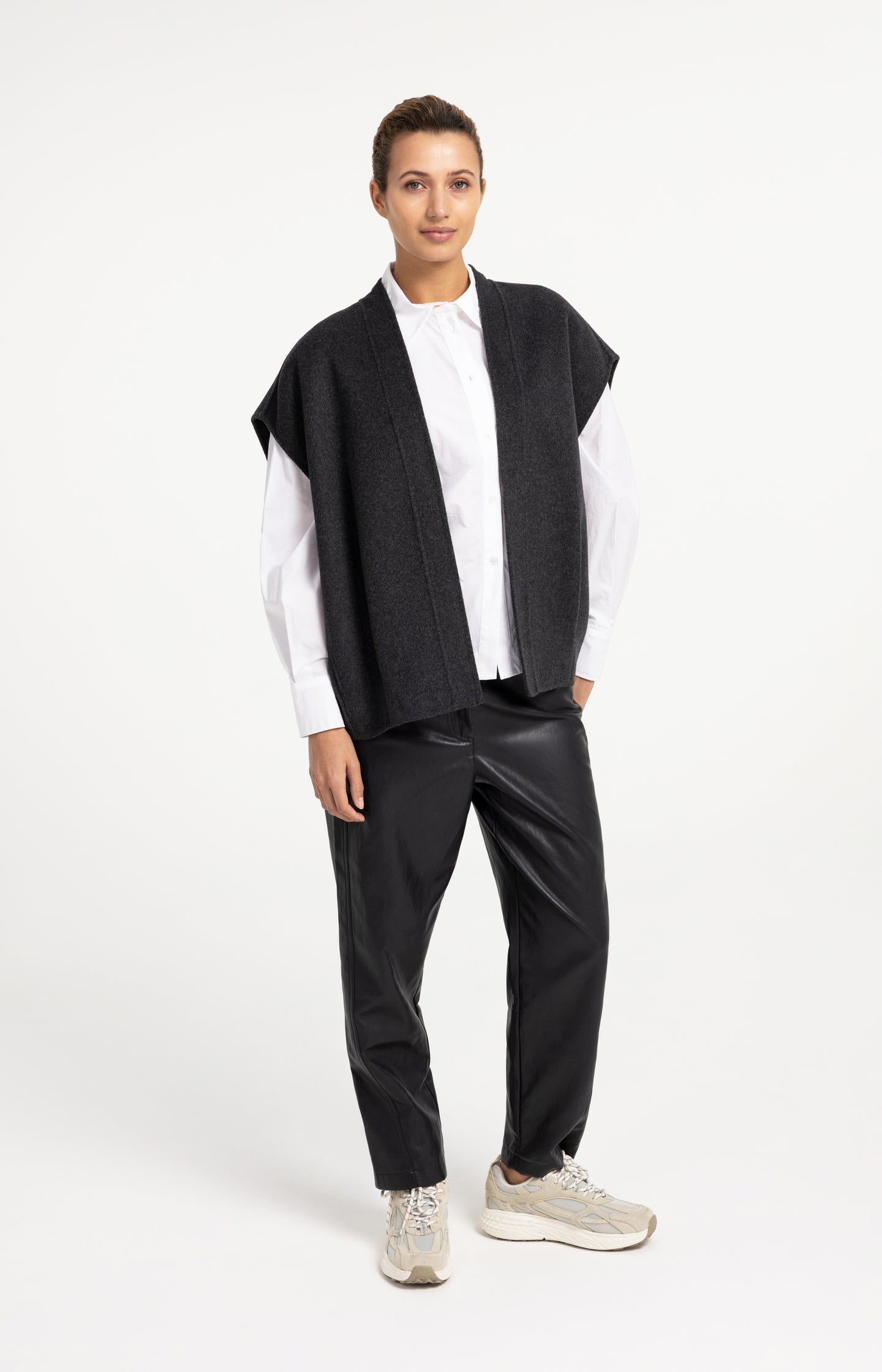 Faux leather carrot fit trousers with seam detail