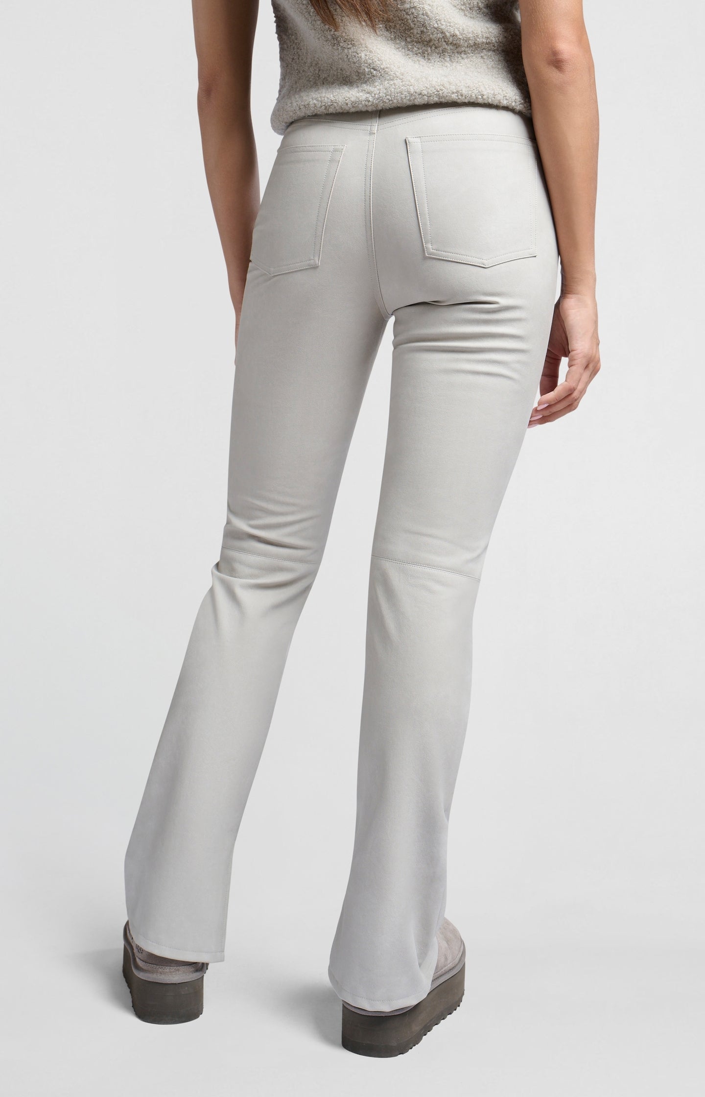 Faux nubuck leather pants with high waist, pockets and slit