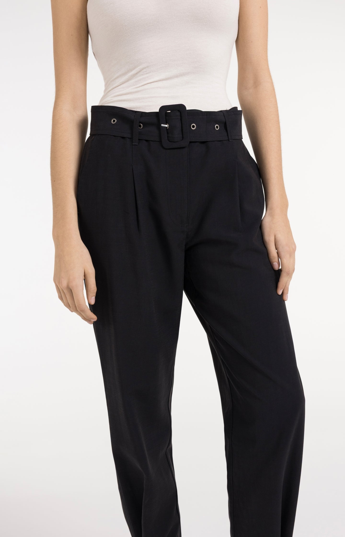 High waist trousers with strap details at the bottom hem