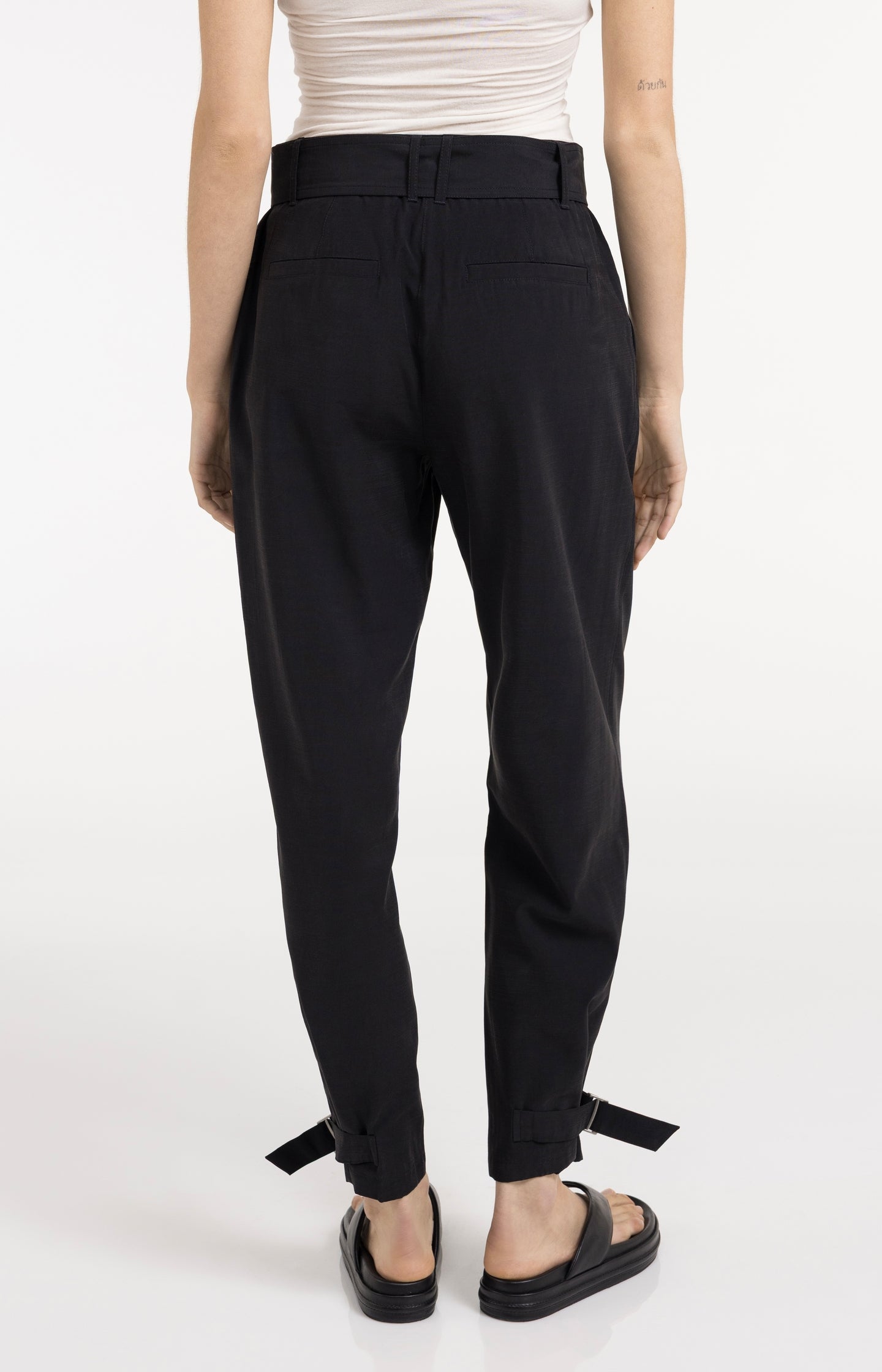 High waist trousers with strap details at the bottom hem