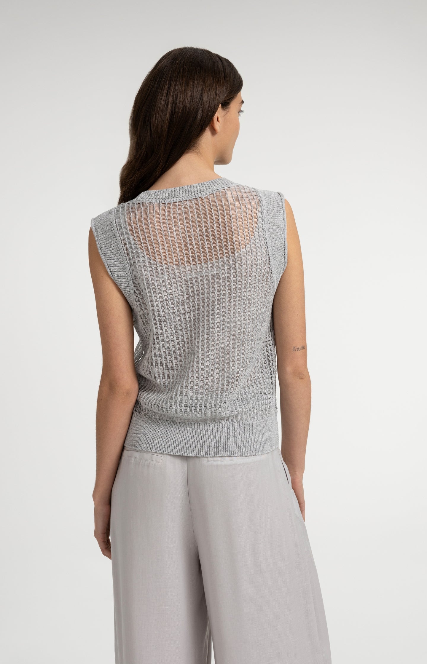 Open-knit top with matching underlayer
