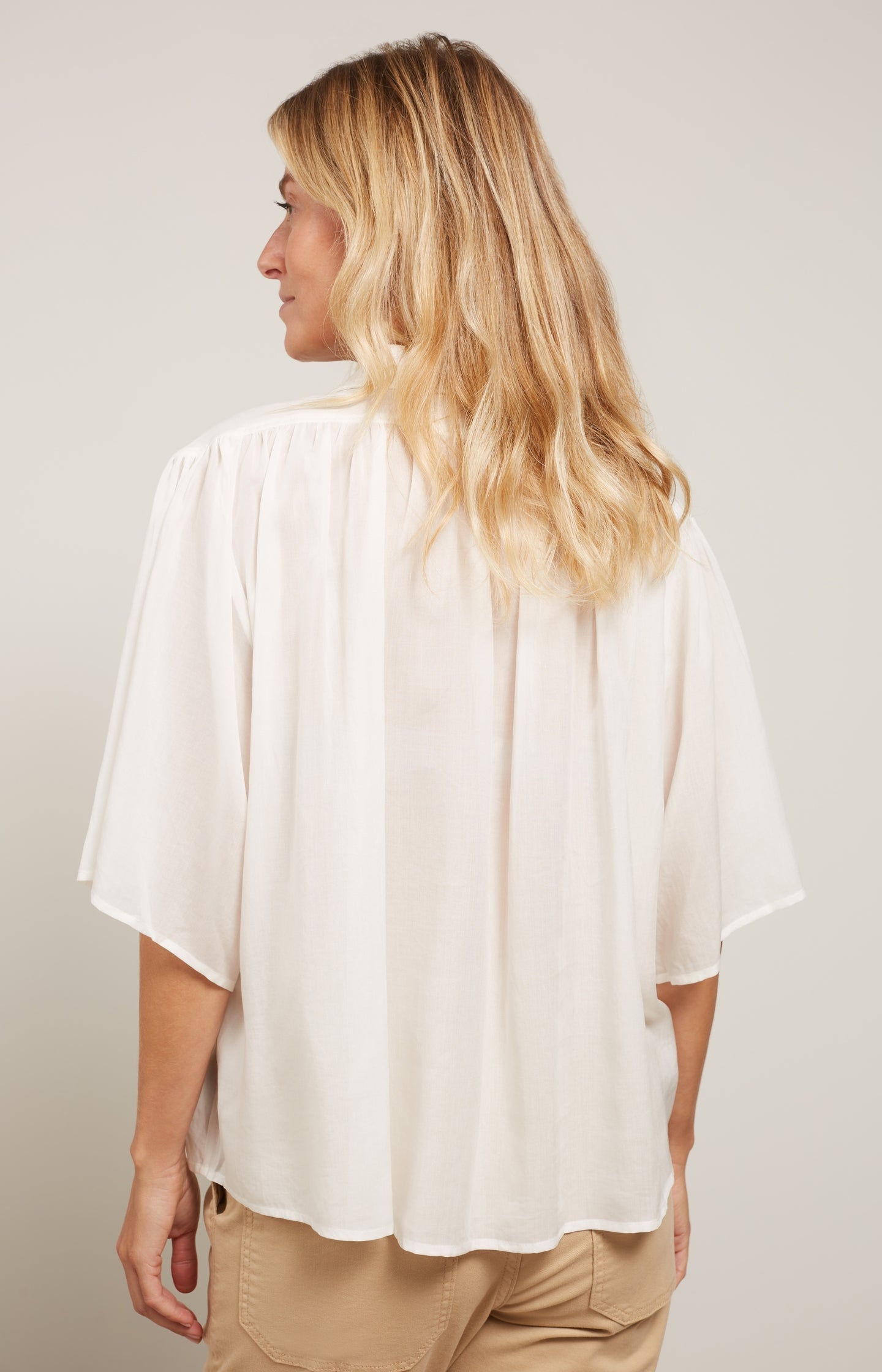 Oversized blouse with wide sleeves and pleated details