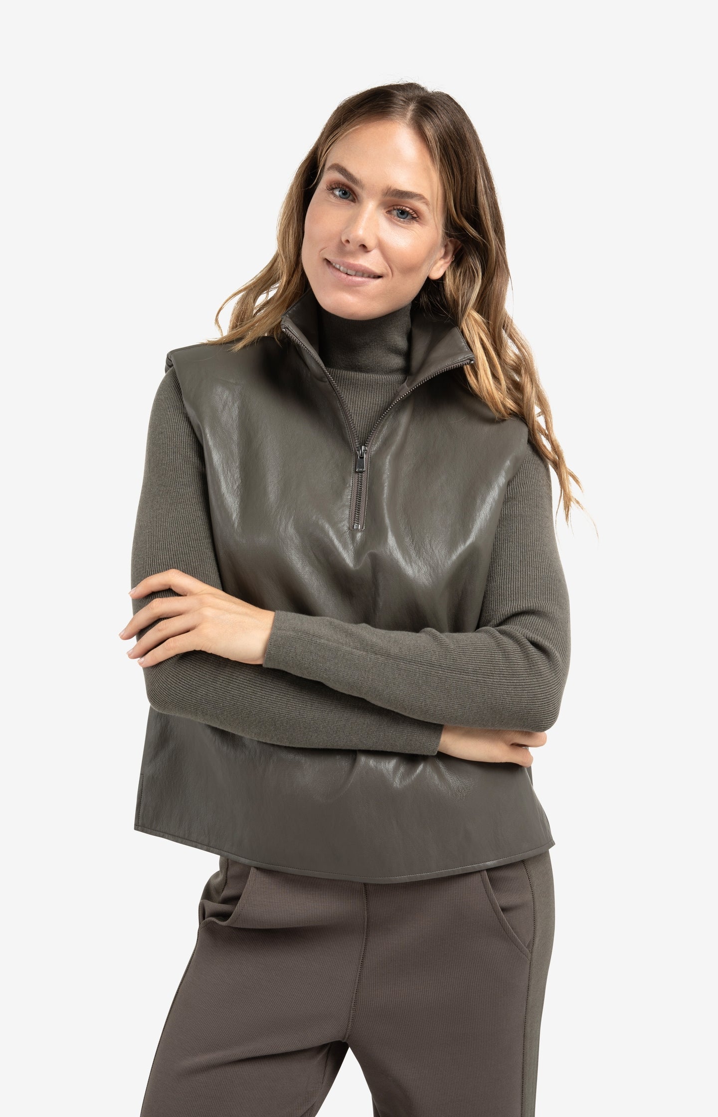 Sleeveless faux leather top with zip collar
