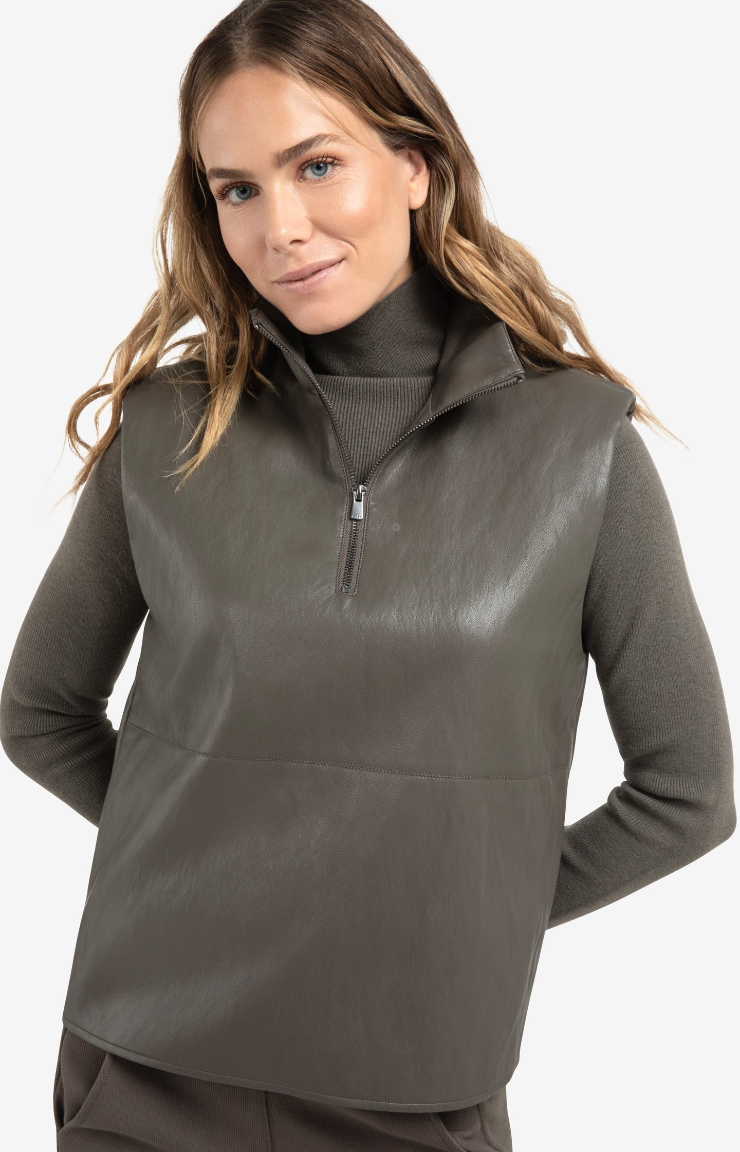 Sleeveless faux leather top with zip collar