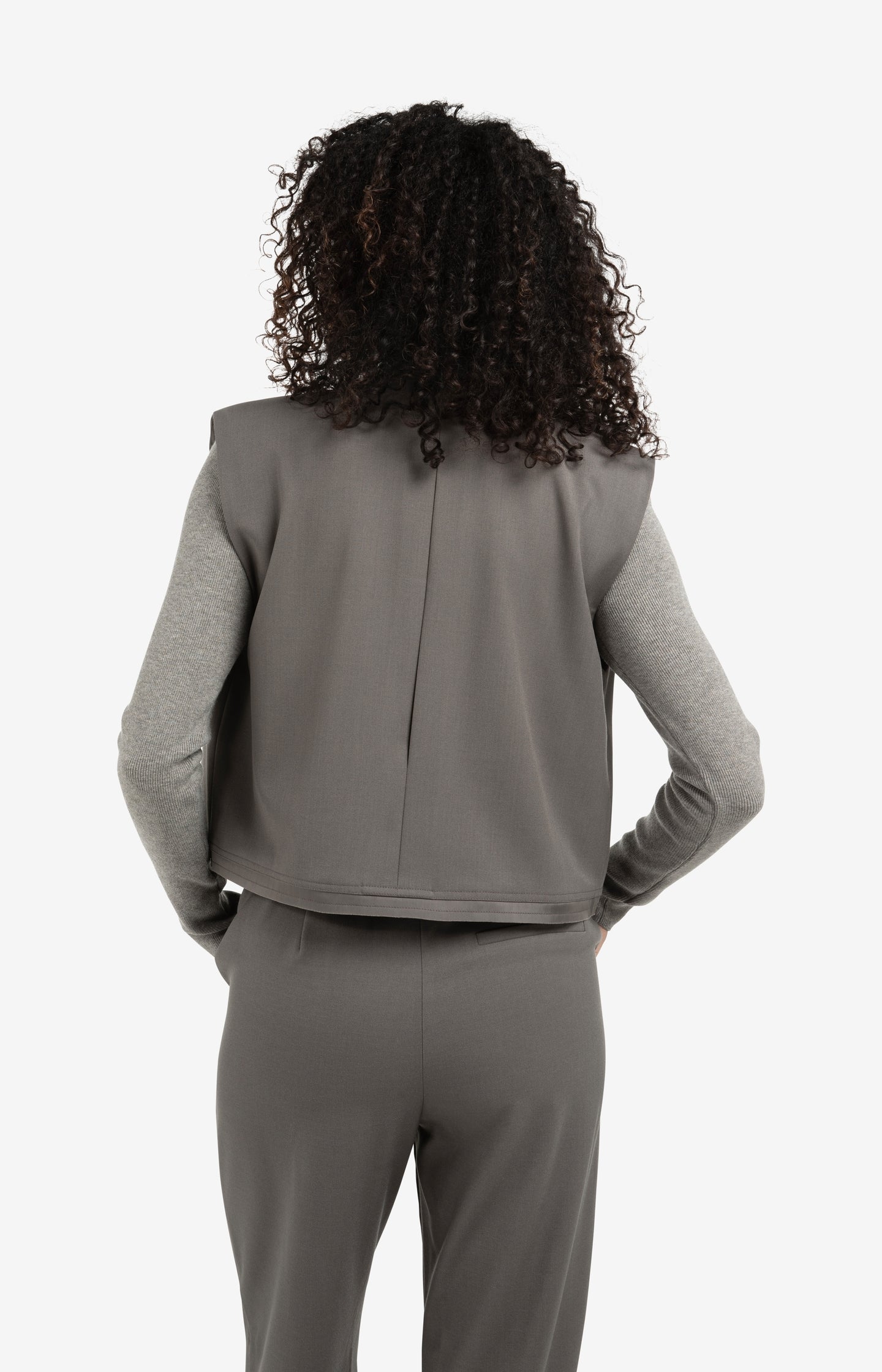 Sleeveless short blazer with double layer effect