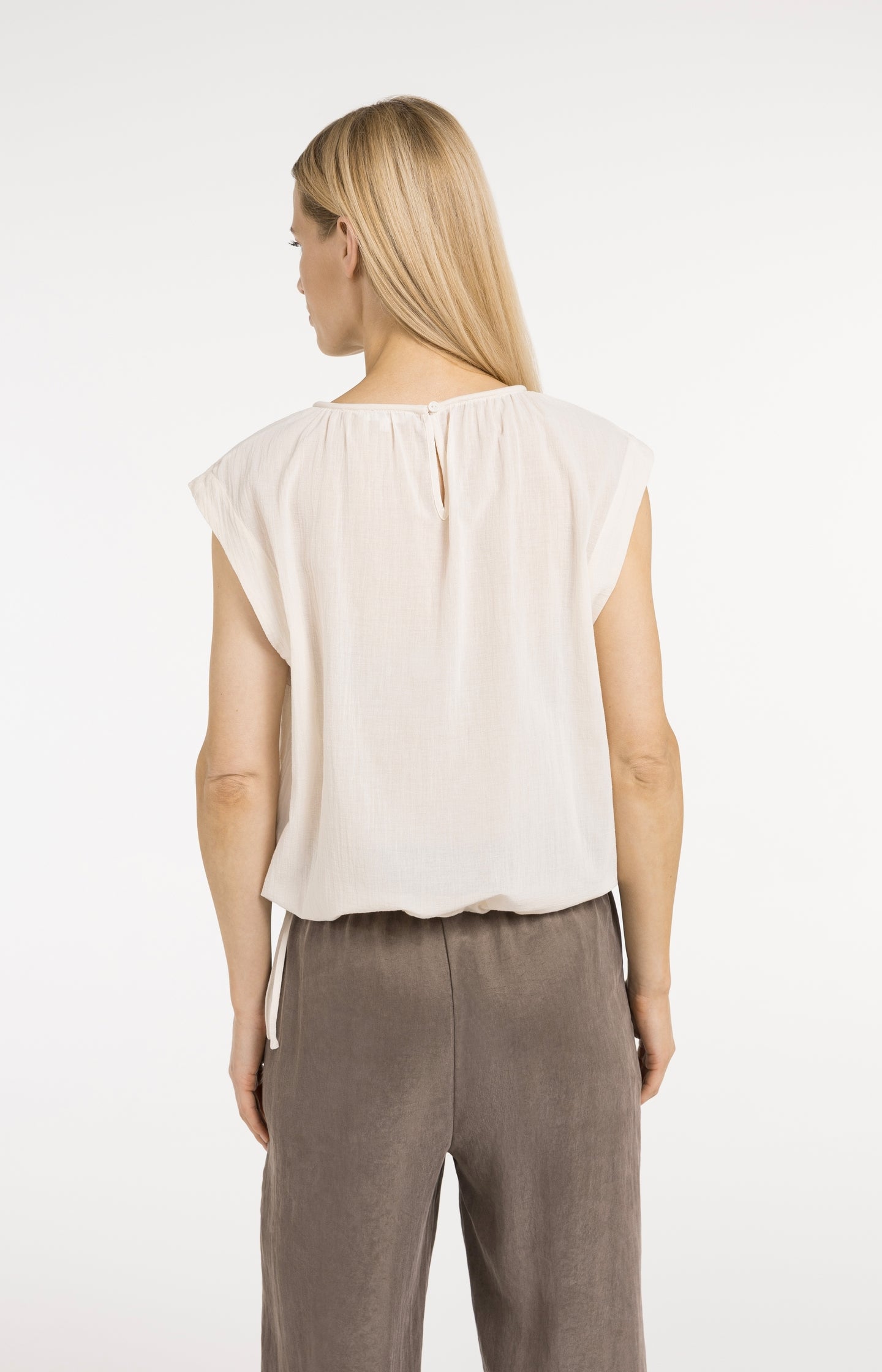 Sleeveless top with pleated neckline and drawstring