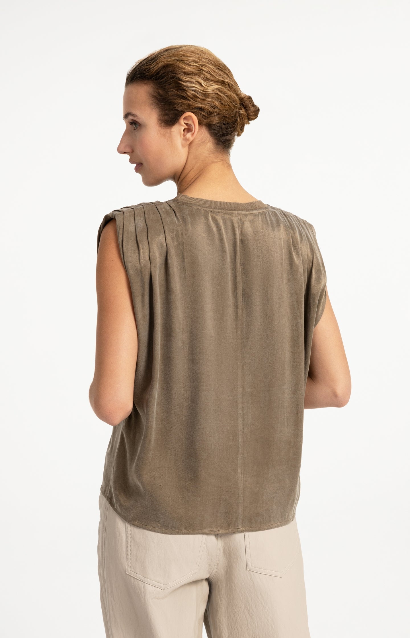 Sleeveless top with shoulder pleats