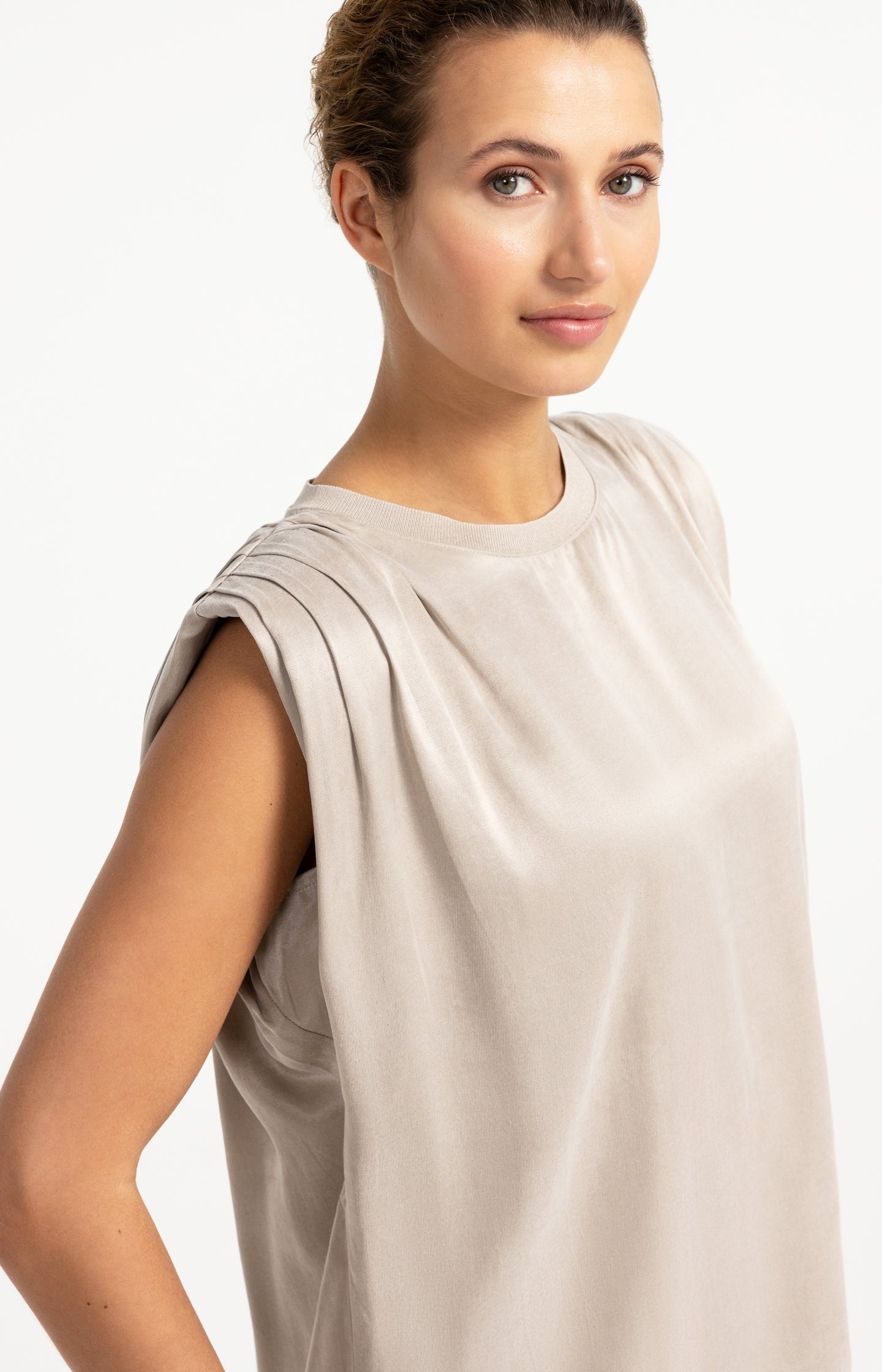 Sleeveless top with shoulder pleats