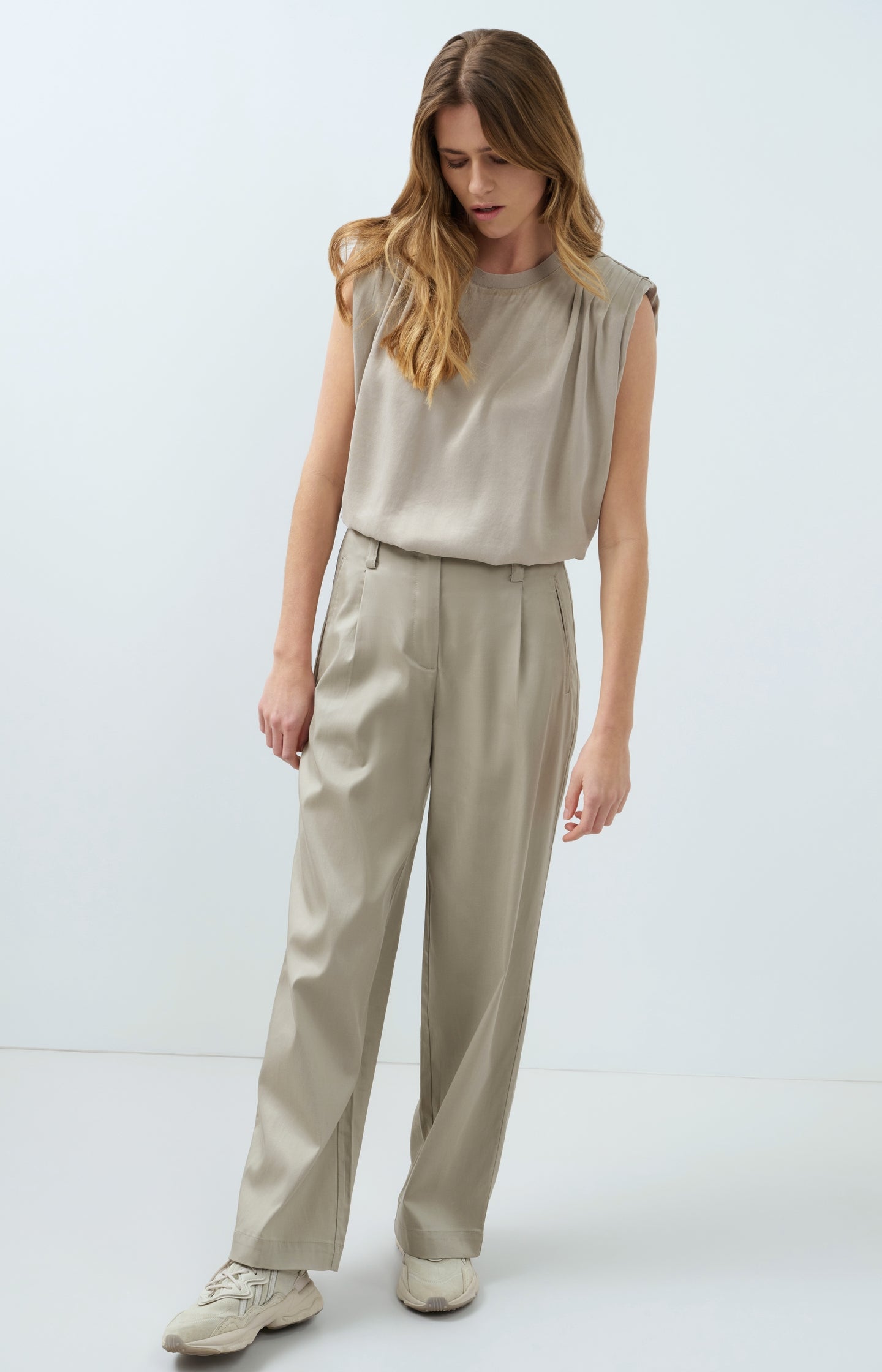 Sleeveless top with shoulder pleats