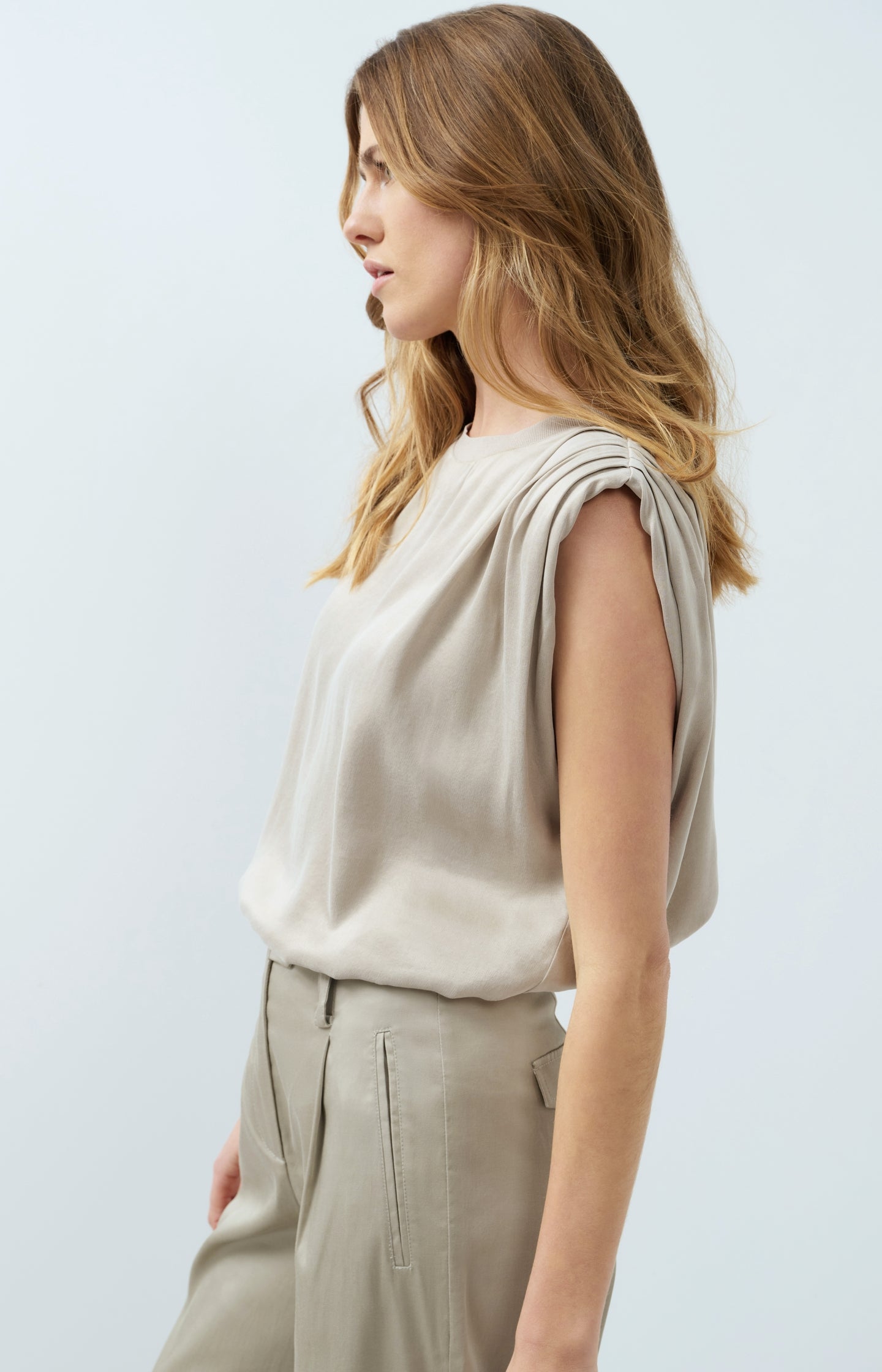 Sleeveless top with shoulder pleats