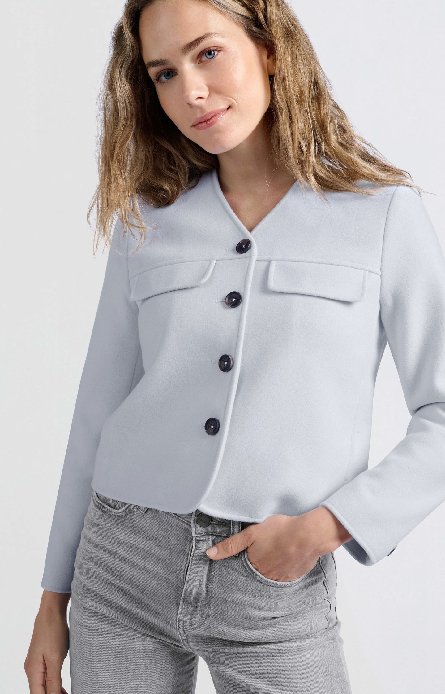 Soft short jacket with chest pockets and button closure