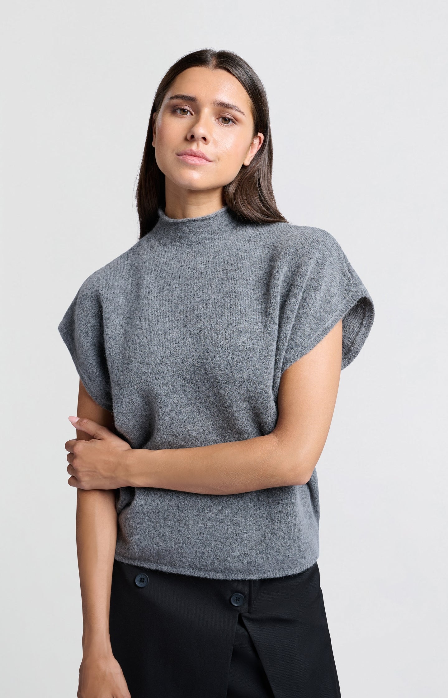 Soft sleeveless sweater with high neck and loose fit