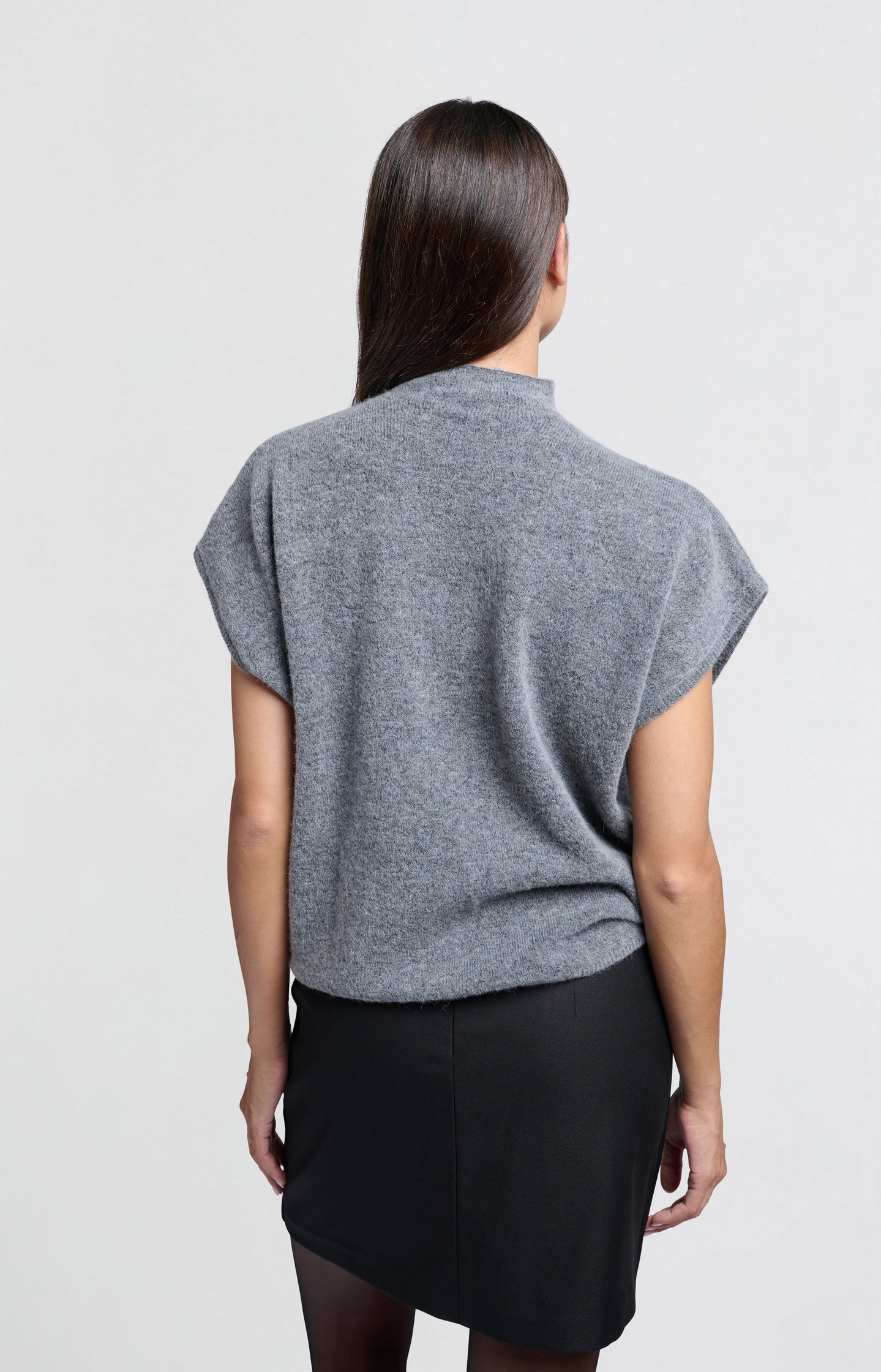 Soft sleeveless sweater with high neck and loose fit