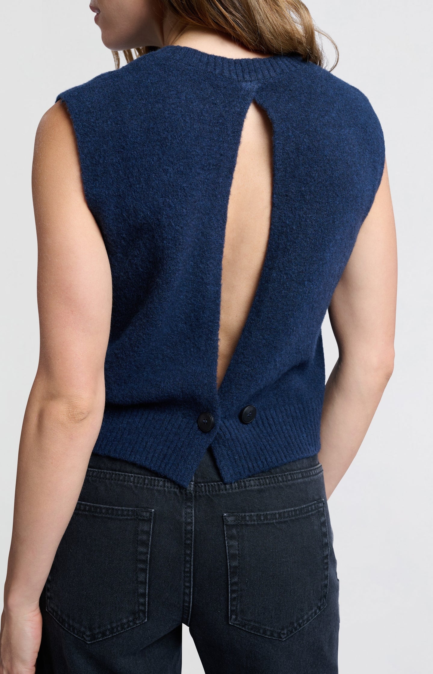 Soft vest with elegant open back and button closure