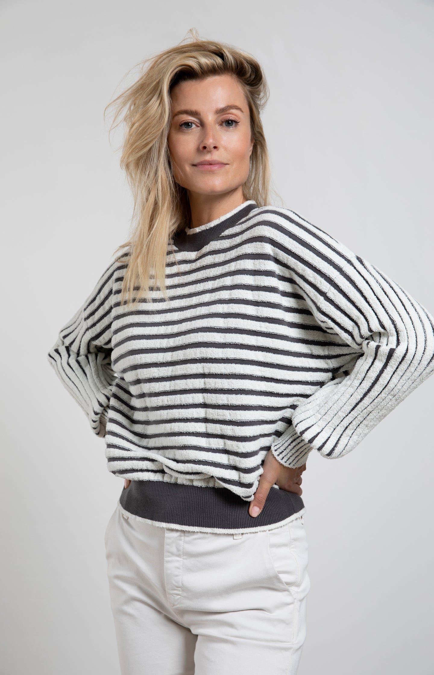 Striped sweater with crewneck, long sleeves and frayed seams