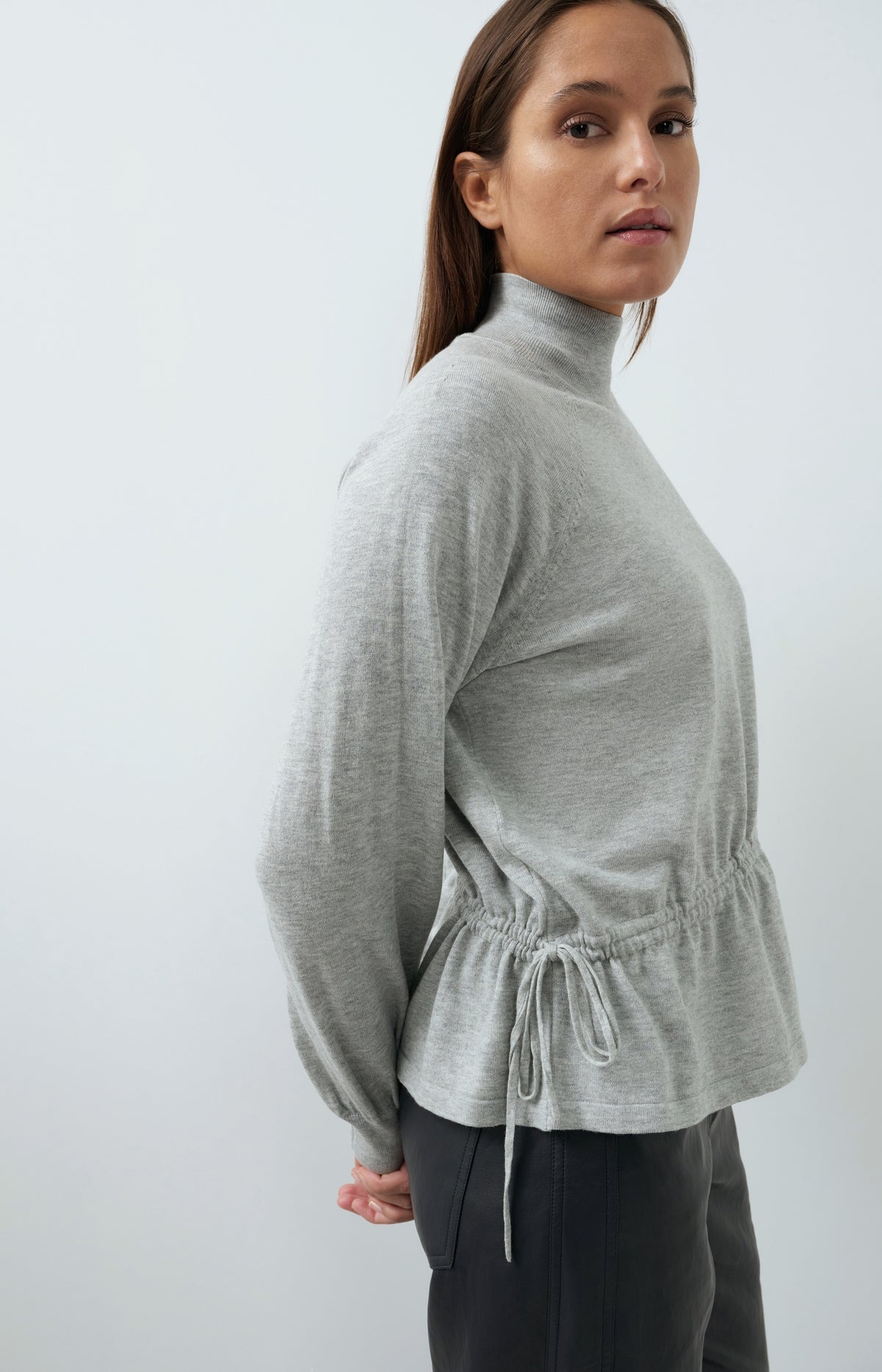 Sweater with high neckline and waist cord