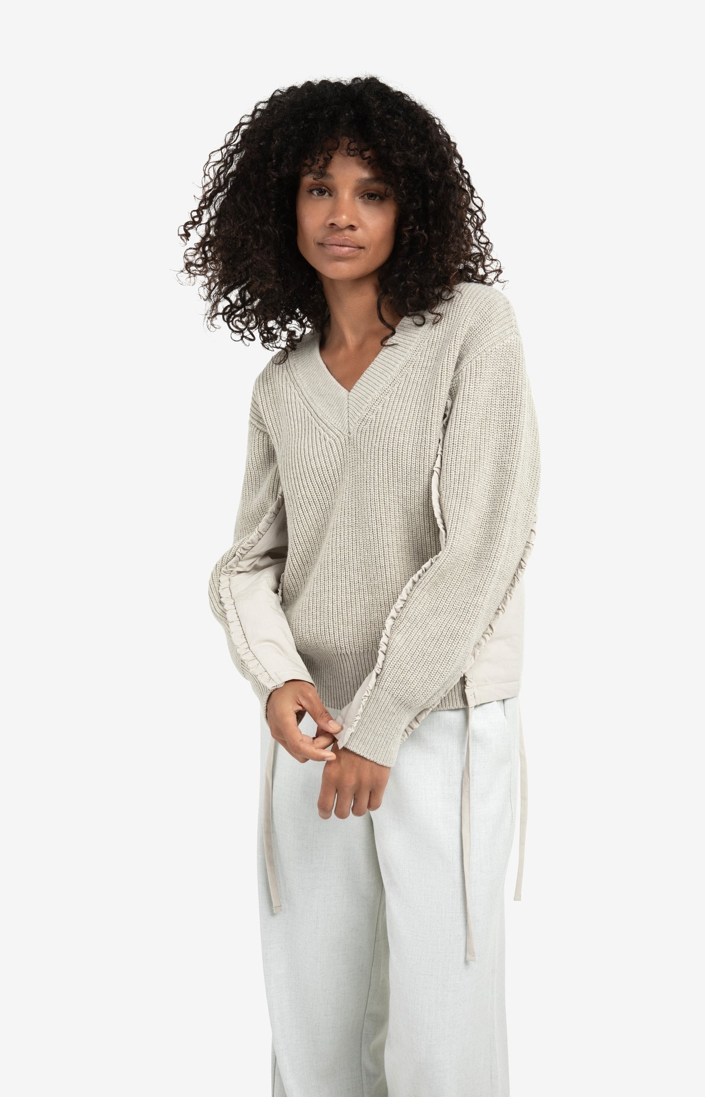 V-neck sweater with woven insert details and tie accents