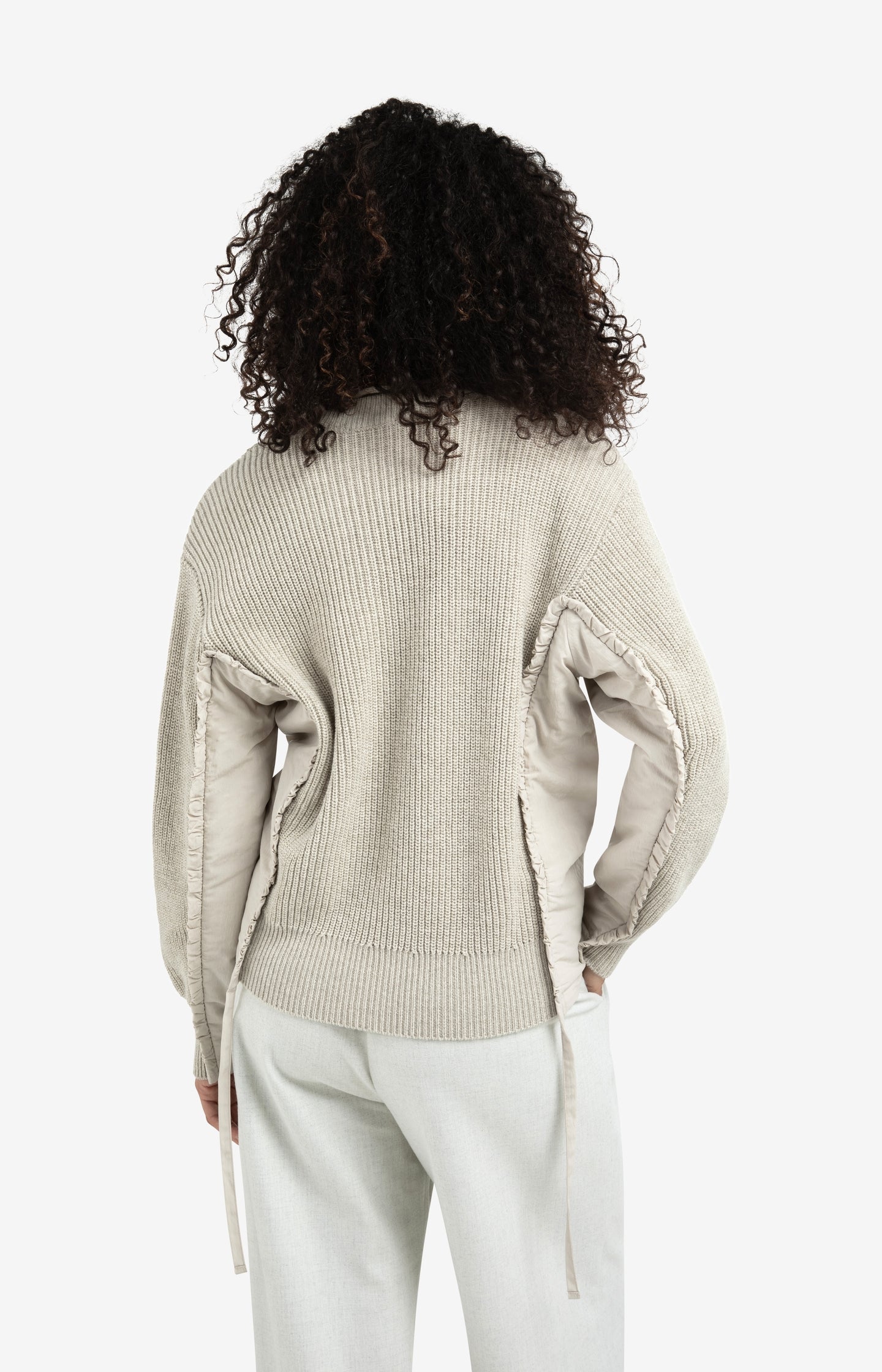 V-neck sweater with woven insert details and tie accents
