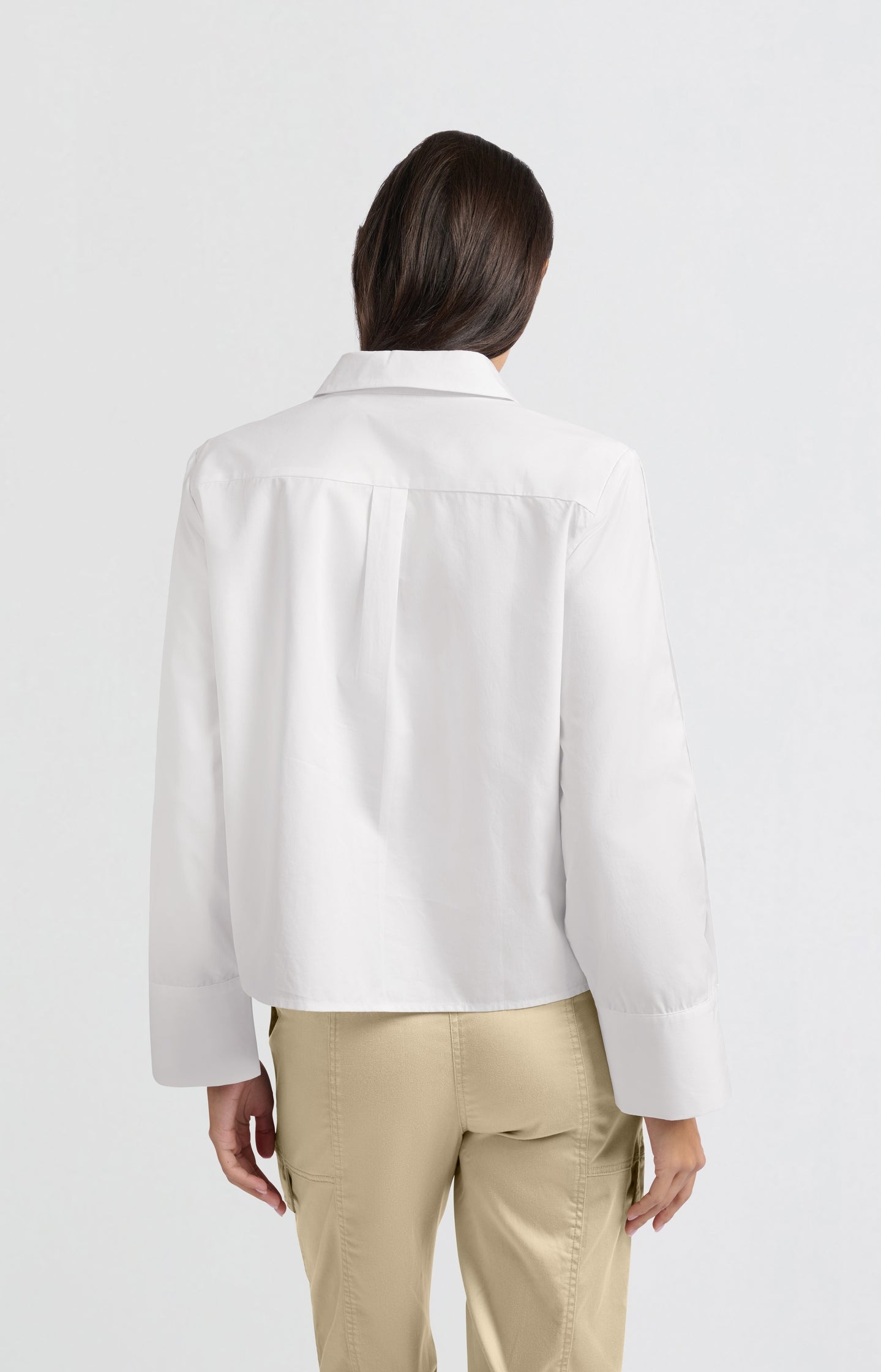 White blouse with long sleeves and button details